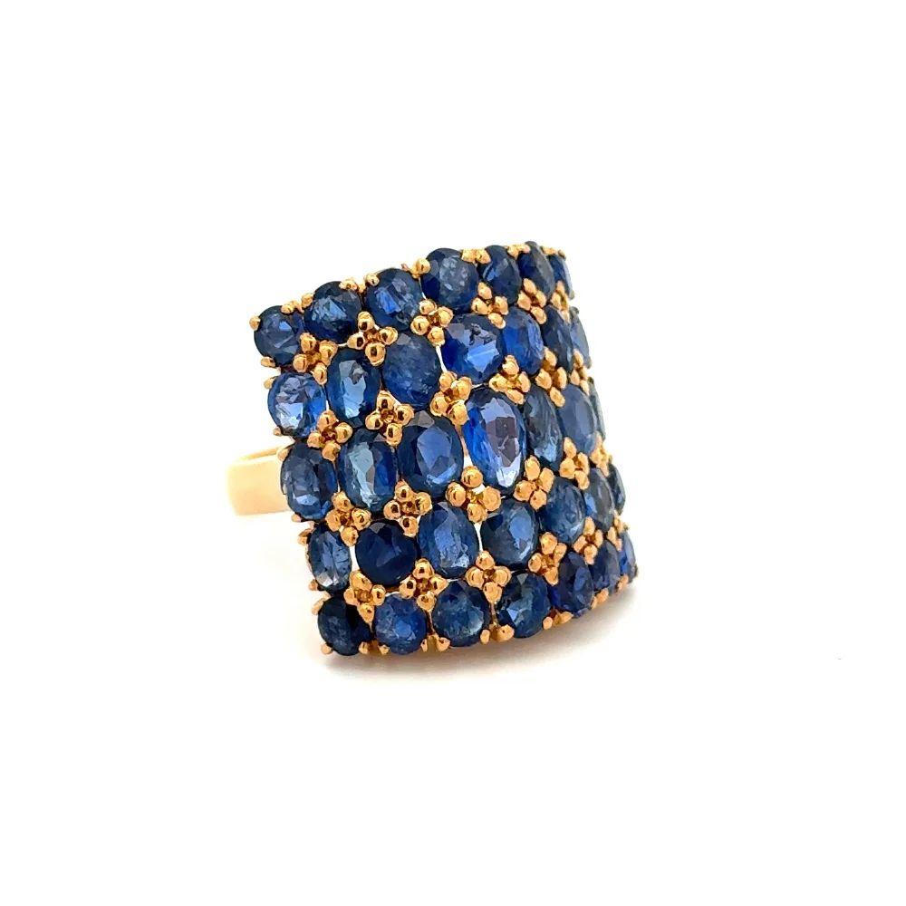 Simply Beautiful! Vintage Oscar Worthy Blue Sapphire Wide Curved Gold Band Ring. Five rows securely Hand set with Oval Blue Sapphires, weighing approx. 4.50tcw. Hand crafted 18K Yellow Gold mounting. Measuring approx. 0.90” l x 0.80” w. Ring size