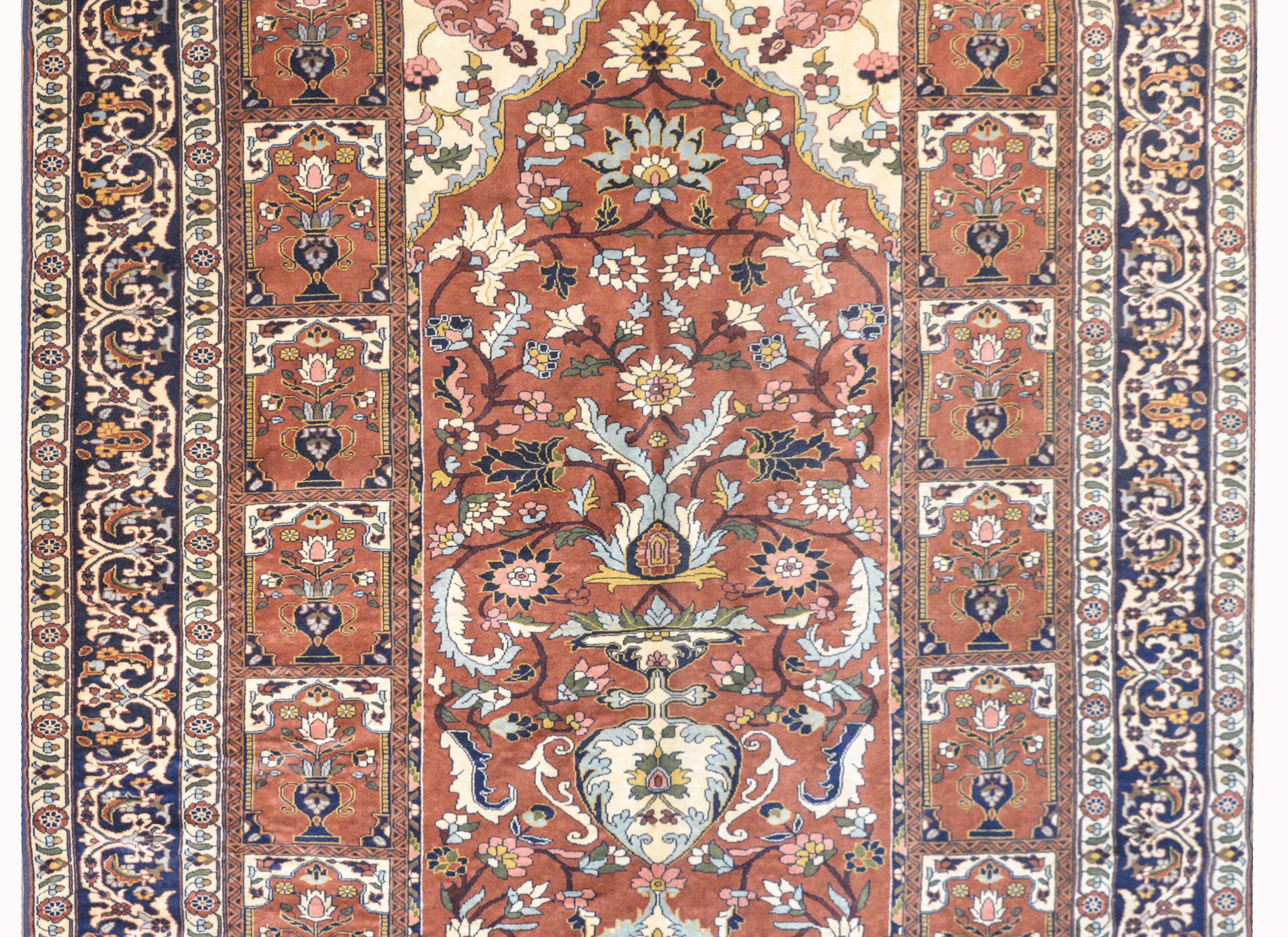 A wonderful vintage Sarakhs rug with a beautiful large patted tree-of-life in the center, surrounded by multiple smaller potted trees-of-life, all woven in rich golds, indigos, pinks, cranberries, and creams. The border is composed of multiple