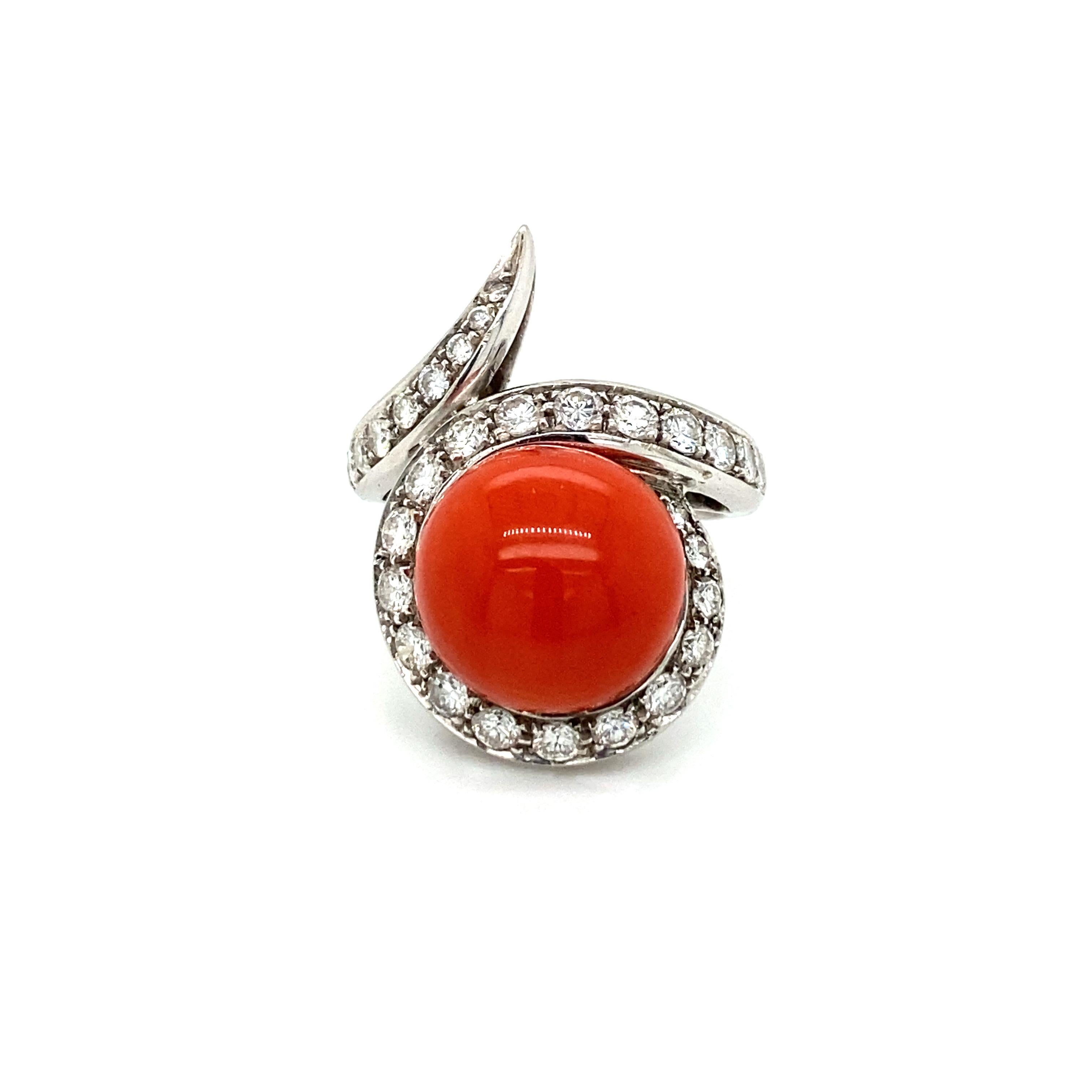 This elegant coral and diamond cocktail ring features a cabochon Natural Mediterranean Coral with a deep Red color, no imperfection or scratches, surrounded by round brilliant cut diamonds totaling approximately 1.50 carat G color VVS clarity. Circa