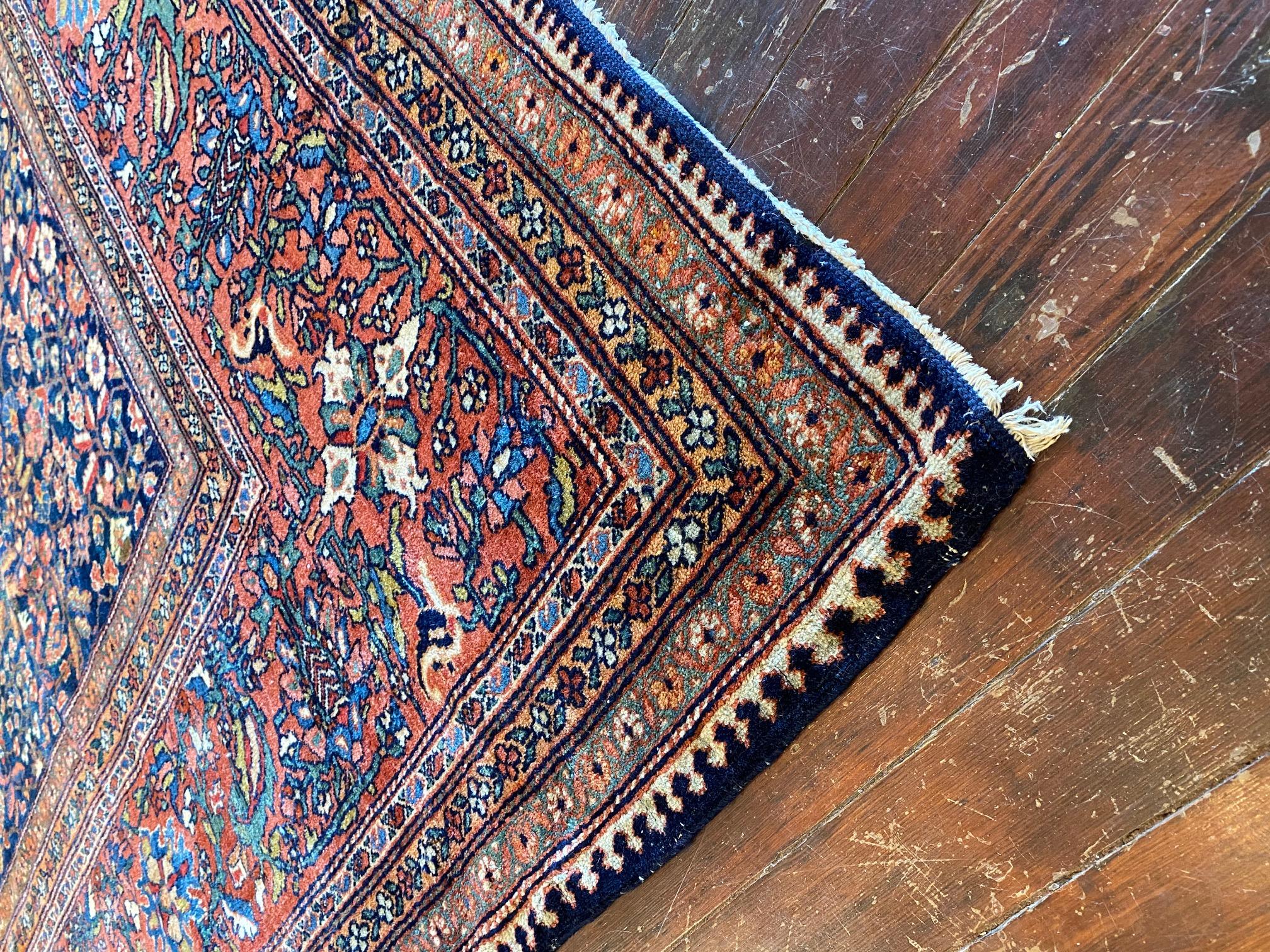 Indulge in the splendor of the magnificent 1900's Persian Sarouk Far Rug, a true masterpiece that exudes timeless beauty. This extraordinary rug commands attention with its incredible size, measuring an impressive 12'x17'5