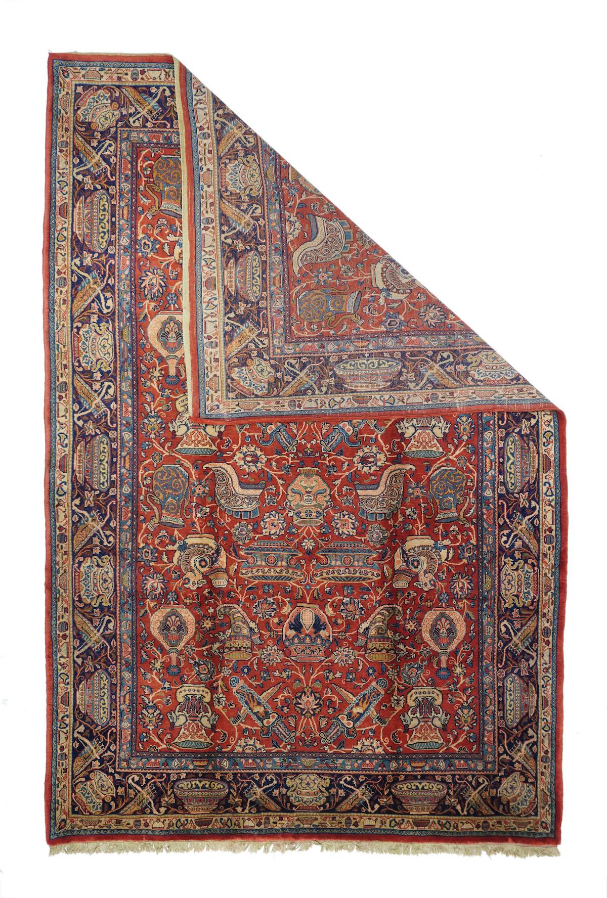 Fine Antique Persian Sarouk Rug 6'11'' x 10'11''. This is one very unusual carpet! The red field displays bottles, vases, swords, daggers, helmets, drinking horns and various other accoutrements, with vinery, leaves and palmettes passing round and