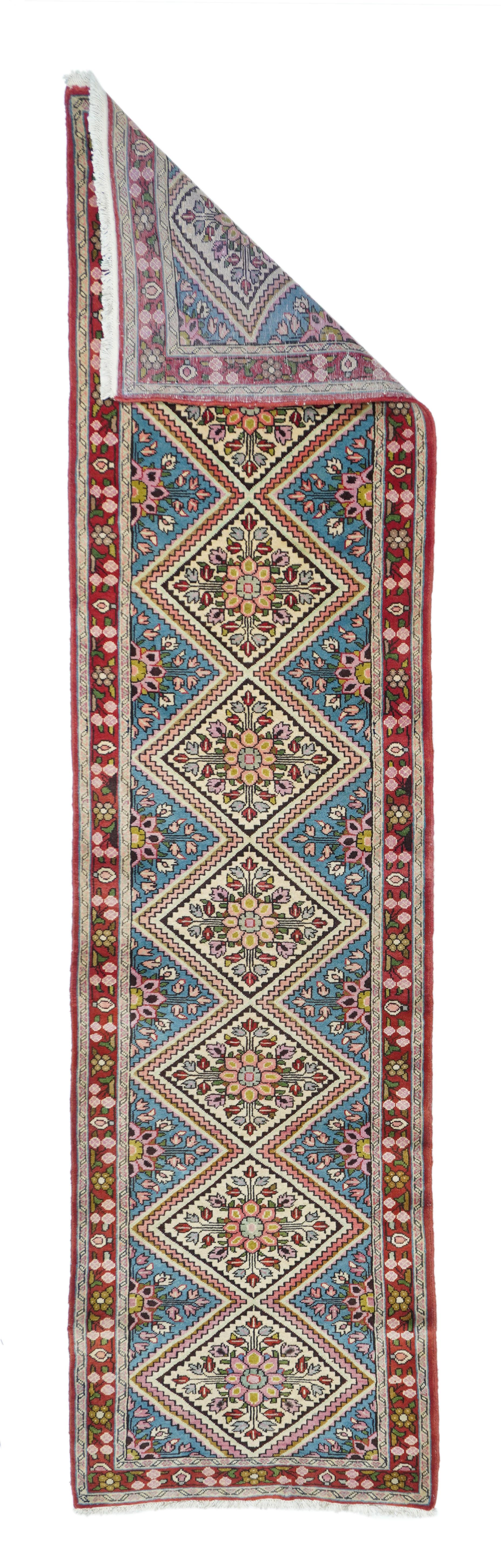 Vintage Sarouk runner. Measures: 2.4'' x 9.11''. The light blue field is relegated to triangles along the sides, while a double zig-zag defines the central pole medallion of eight complete lozenges with octofoil rosette centres. En suite