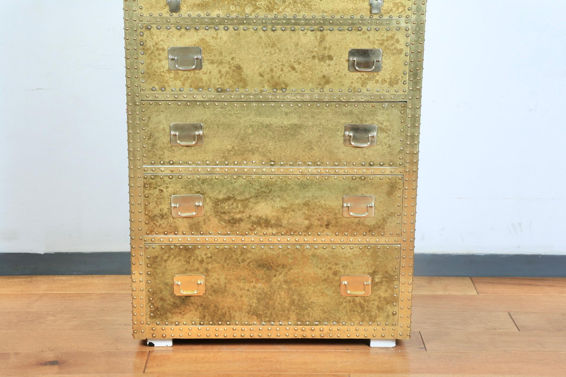 Beautiful brass Sarreid highboy dresser with working drawers. Well kept brass accent Highboy with brass pins as well. No major scratches or damages. Has wooden legs.