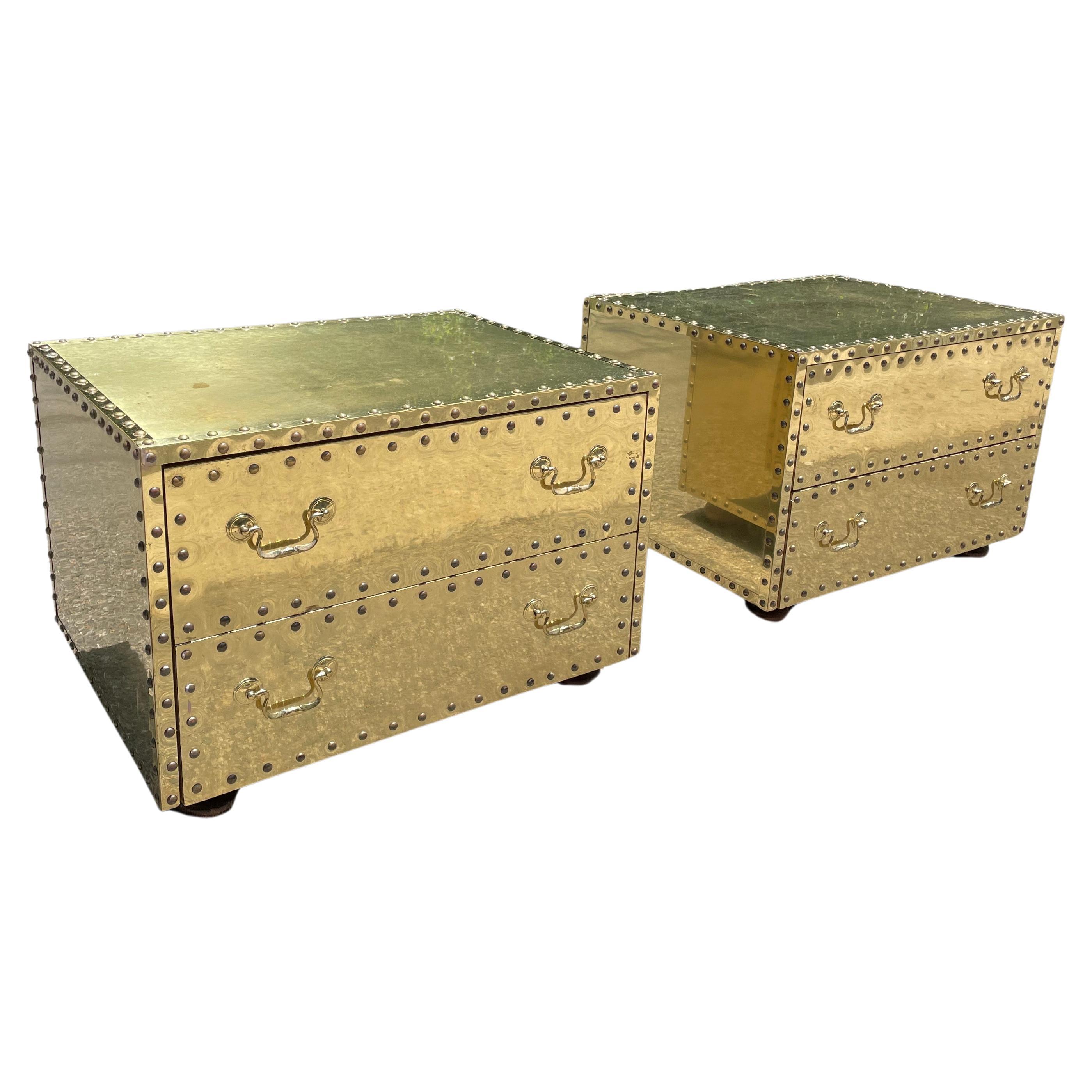 Two drawer mid-century glamorous nightstands / end tables by Sarreid. Circa 1970s.

These are clad in brass with nailhead trim. Two drawers per nightstand.

This glam piece pairs well with mid-century, hollywood regency, post modern, danish