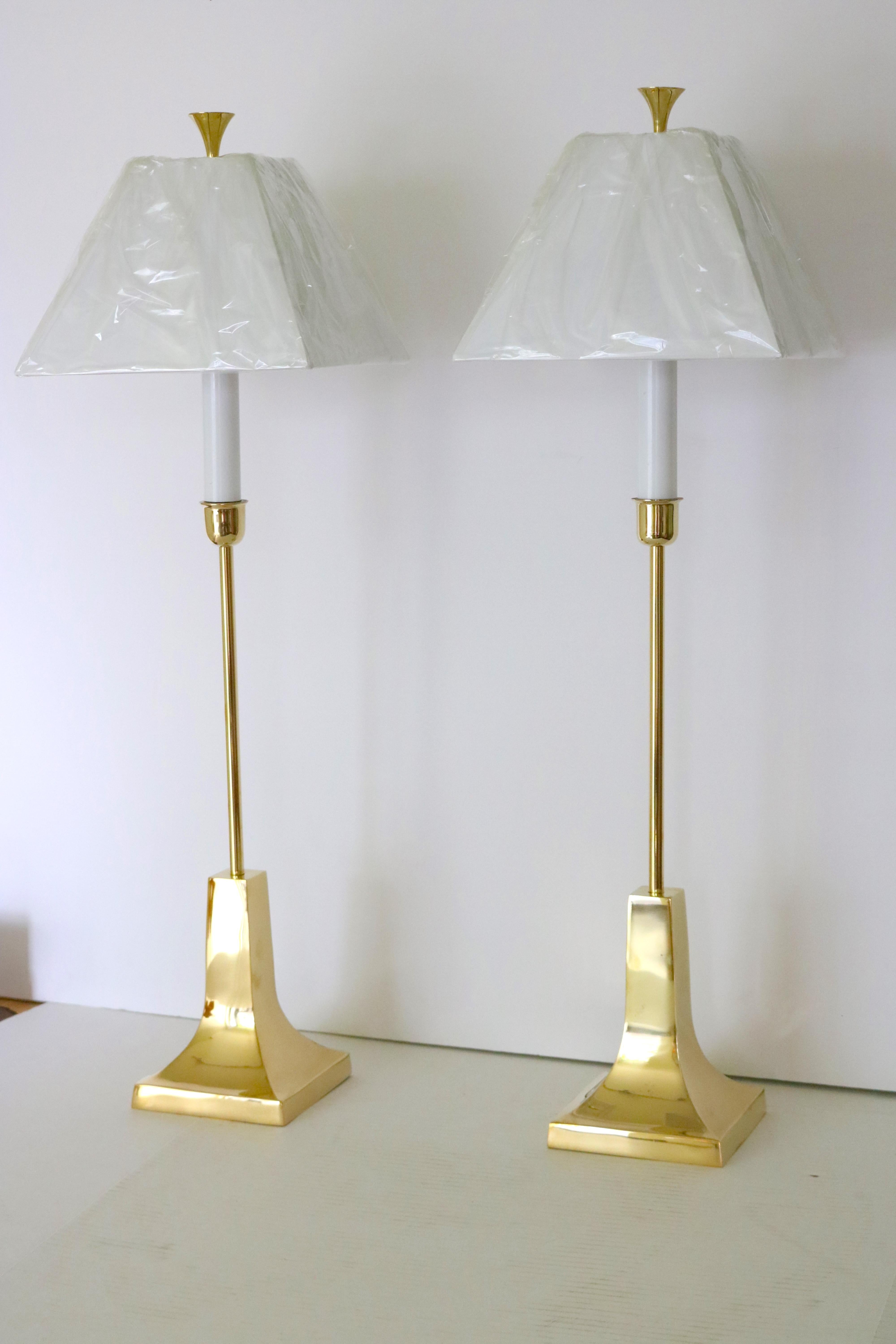 Pair of Sarreid Ltd. Mid-Century Modern, circa 1980s elegant tall polished candlestick brass lamps on square, fluted bases with slender brass tube body and circular flat top finials. Included are, exact as original design, new white shades( still in