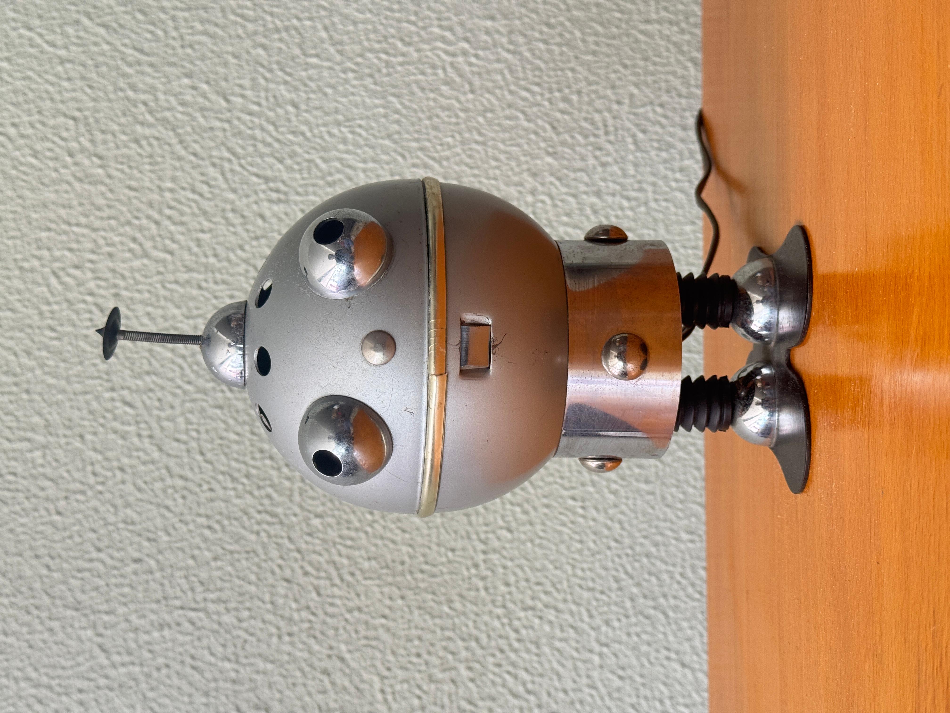 Vintage Satco Robot Lamp – Atomic Space Age Toy Design, c.1950s–60s

An iconic piece of mid-century whimsy, this vintage robot lamp—attributed to Satco (S.A.T. Co)—embodies the playful futurism of Atomic Space Age toy design. Made in the late 1950s