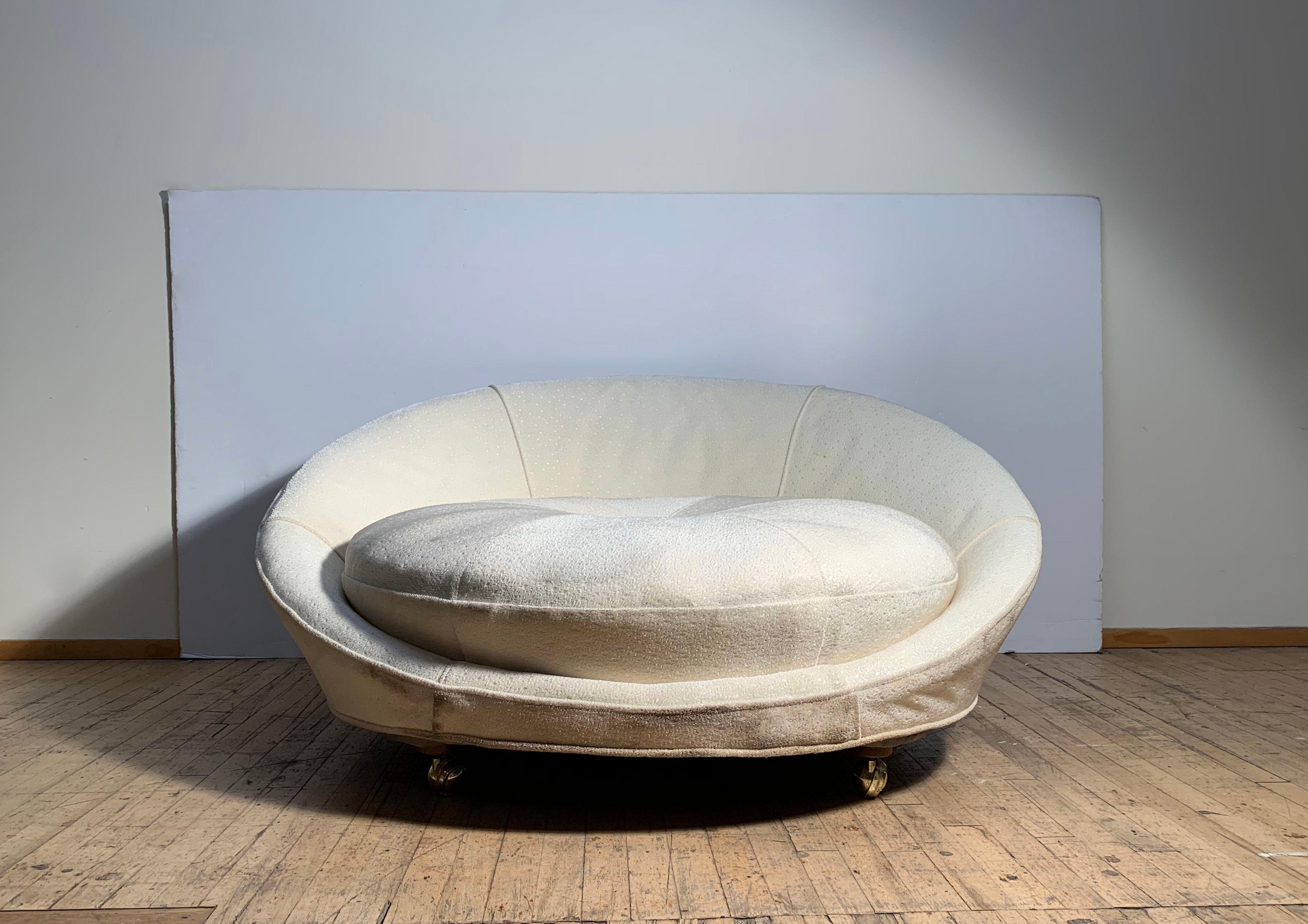 A vintage satellite sofa lounge chair in the style of Milo Baughman. Uncertain to designer. Possibly Adrian Pearsall.

This item will need to be reupholstered. Structure seems sound with working castors.