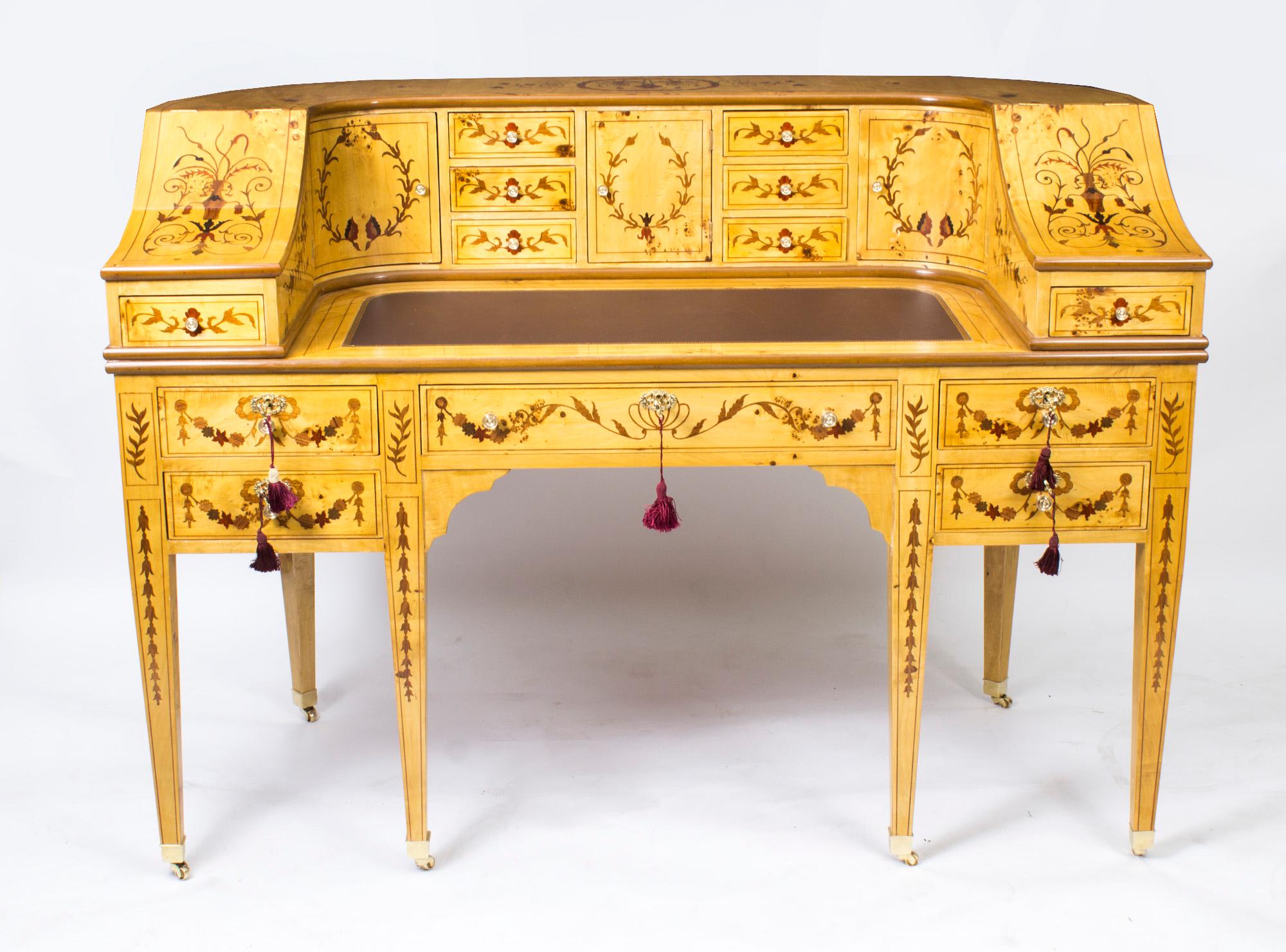 Here we have a very attractive Carlton House Desk which has been hand crafted from the very finest satinwood and decorated with inlaid marquetry and dates from the late twentieth century.
The ornate and fascinating marquetry work includes floral