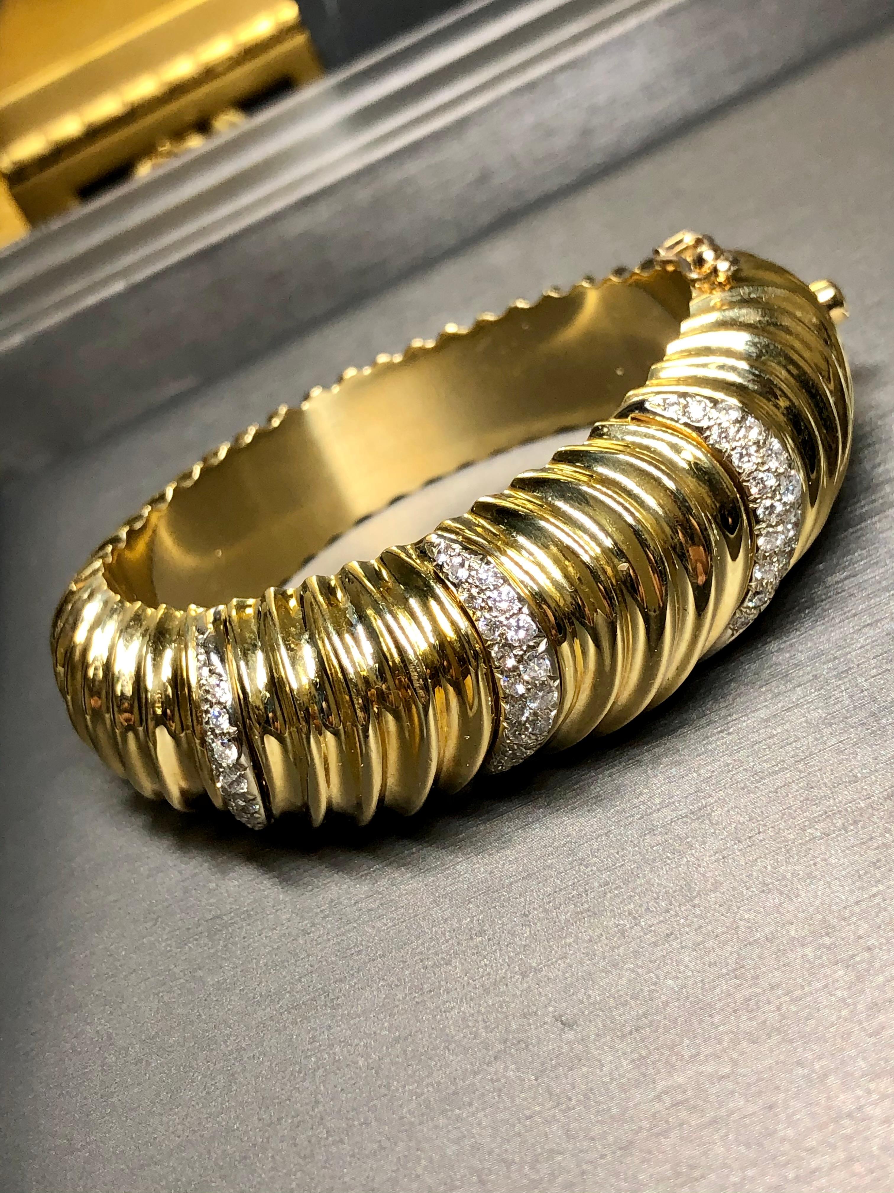 A fabulous Ruth Satsky cuff done in supple 18K yellow gold in a graduating ridged or scalloped design and bead set with approximately 2cttw in G-I color Vs1-2 clarity round diamonds. Has a very secure box clasp with additional safety. It’s such a