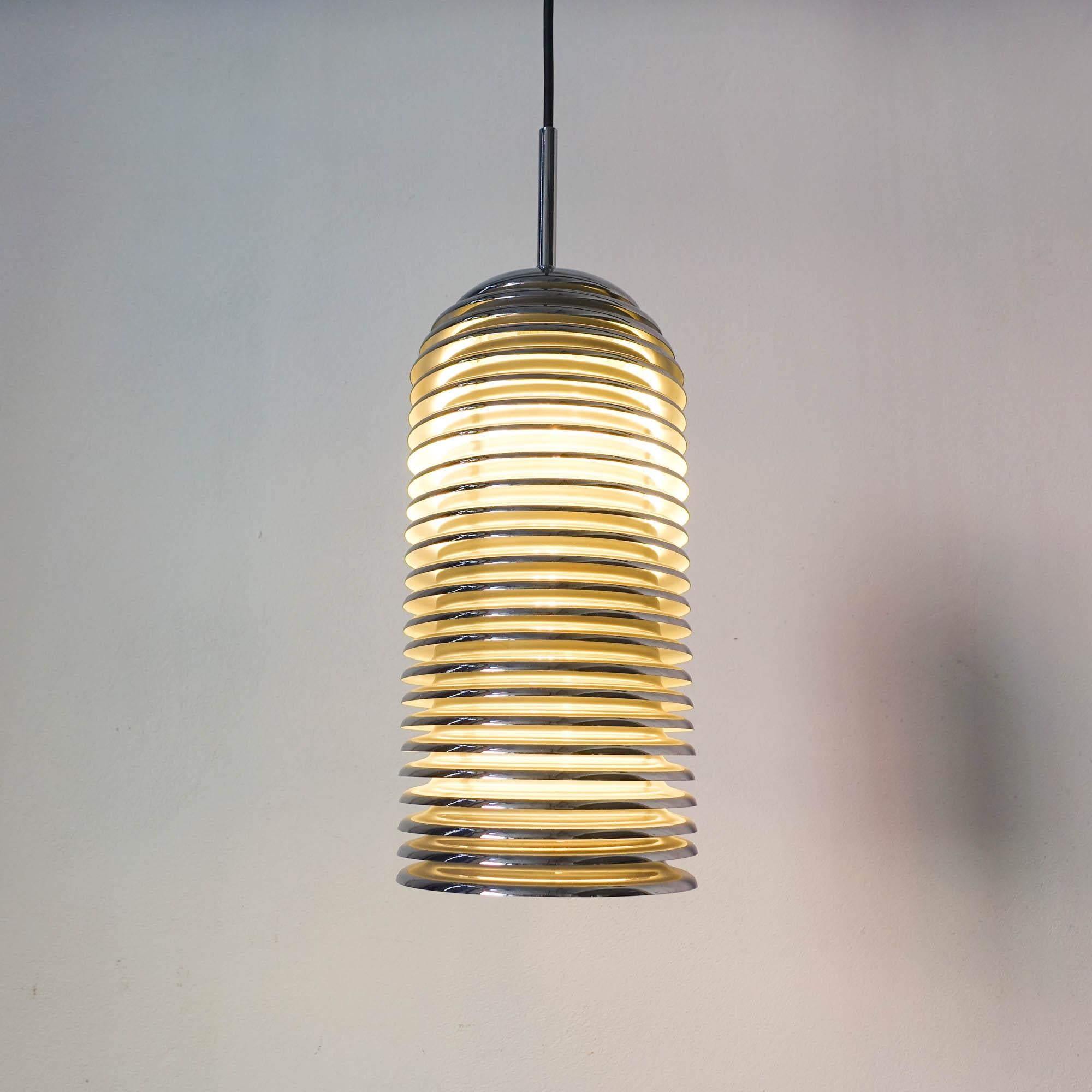 The Saturno pendant lamp was designed by Kazuo Motozawa for Staff Leuchten, during the 1970's. The Saturno Collection won the IF design award in 1972. The light has a 50 cm height chromed metal shade with 24 round rings. It has two standard sockets