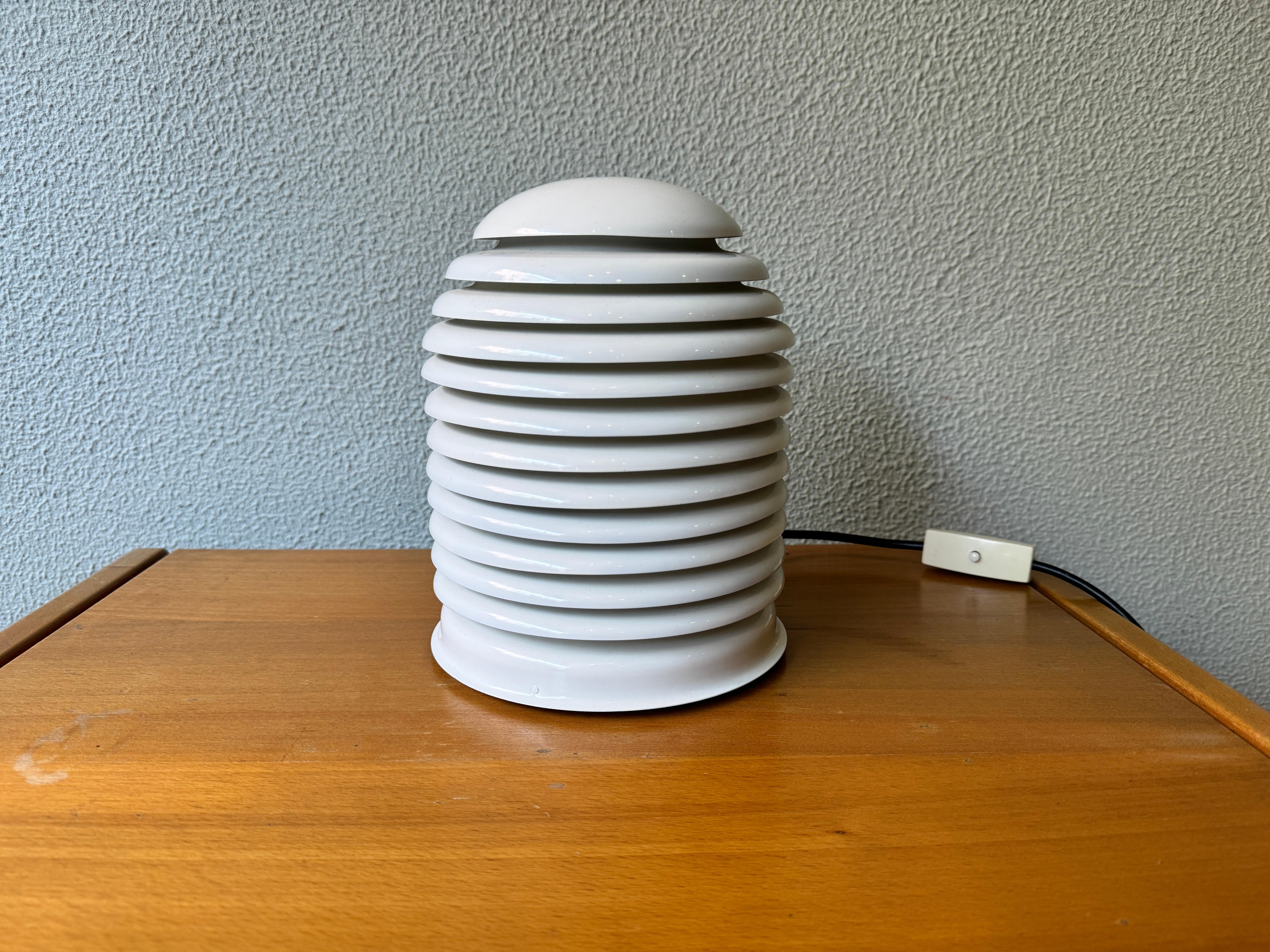 Introducing the stunning Vintage Saturno Table Lamp by Kazuo Motozawa for Staff Leuchten, a true gem of the 1970's. The Saturno Collection was a recipient of the prestigious IF design award in 1972, and it's easy to see why. With a unique off white