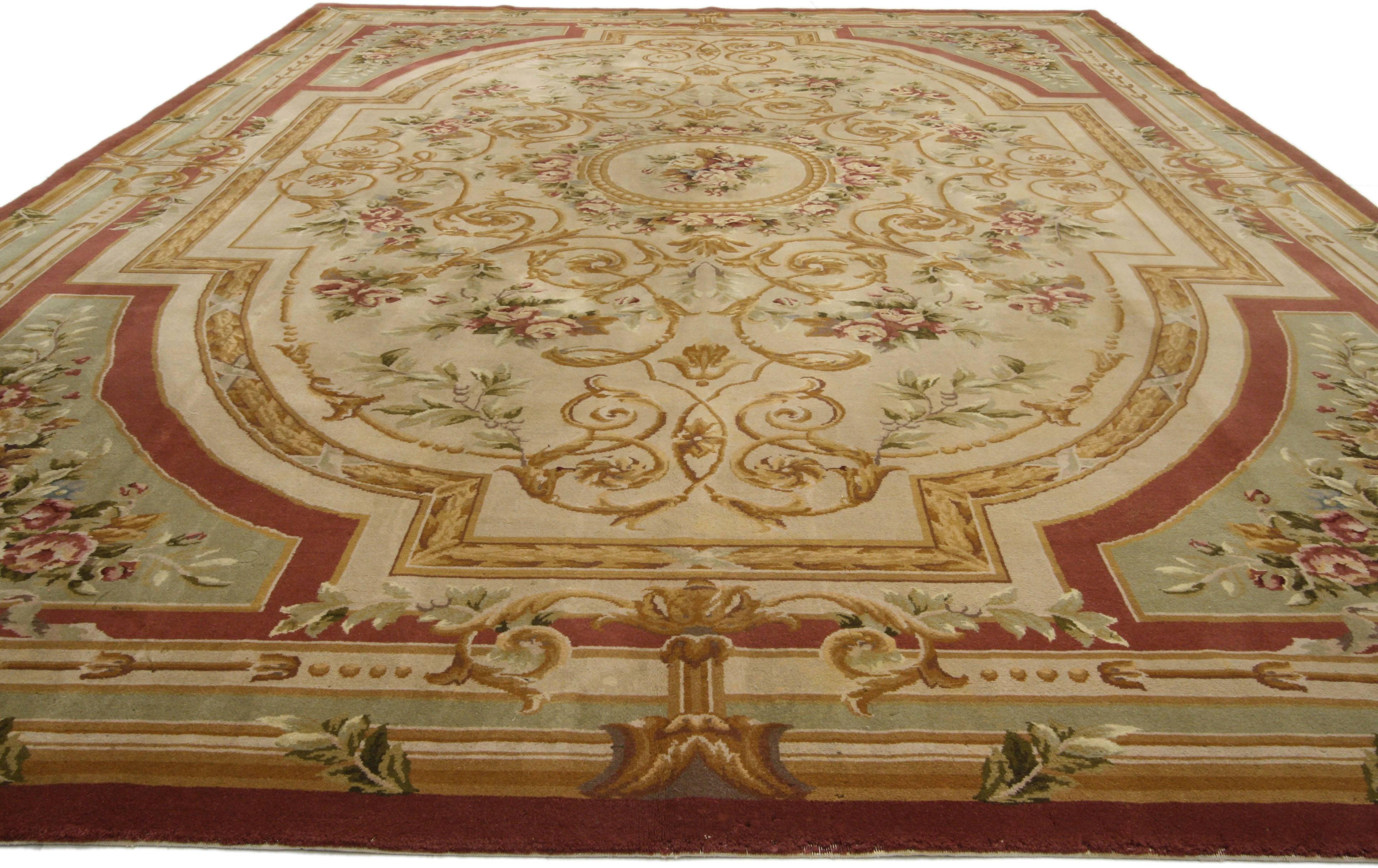 74381, vintage Savonnerie style area rug, Aubusson design rug. This vintage Savonnerie style area rug showcases a compartmentalized composition set with beautiful big pink floral bouquets. Like a garden design with architectural details, a cut out