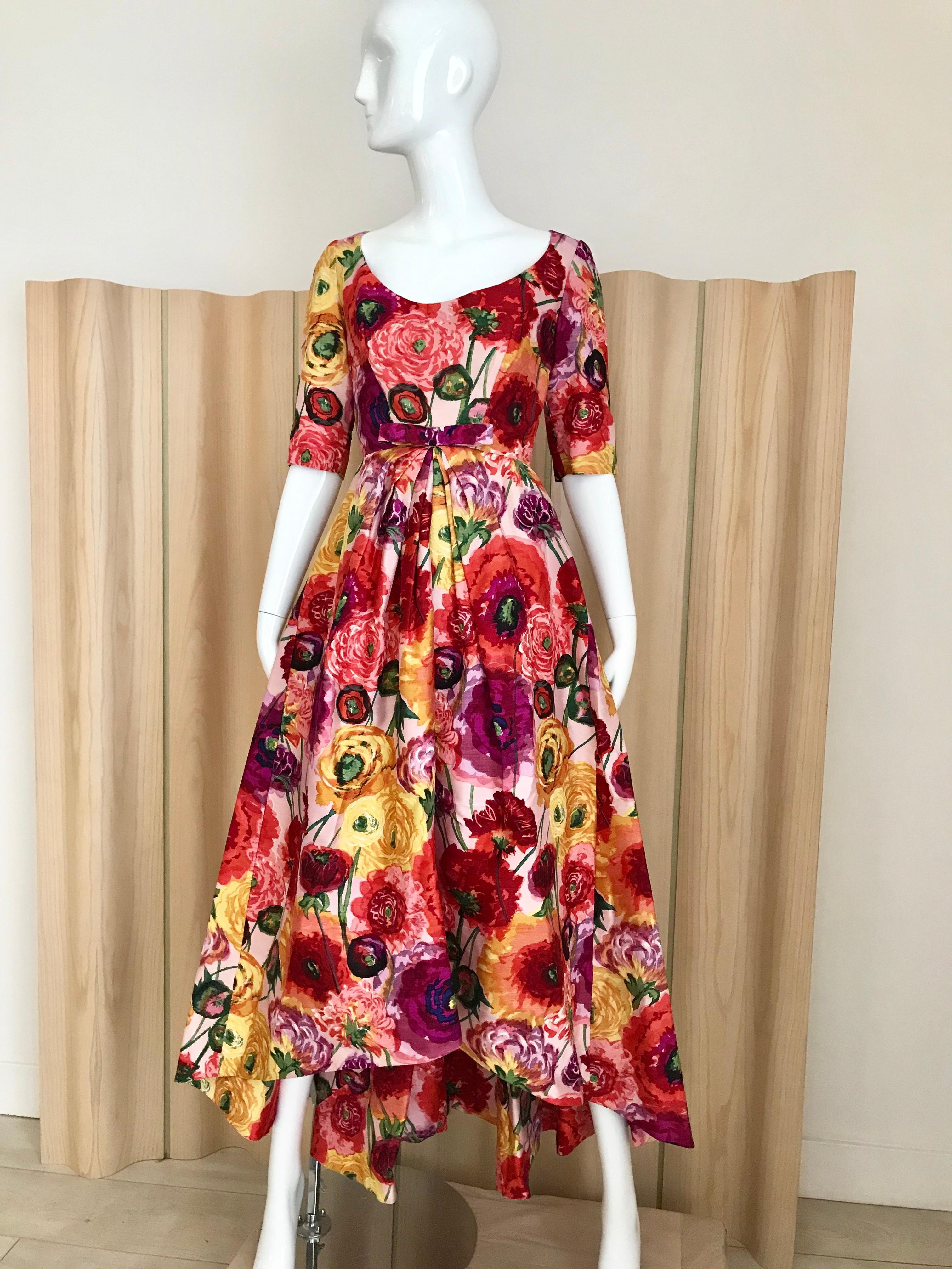 Beautiful late 50s - 60s Silk Floral Print designed by Arnold Scaasi. 
Rich hue floral print in marigold, magenta, purple and green. Truly elegant vintage gown. Perfect for any event. XS/ Very Small. 
Bust: 32 inches/ Waist: 24 inches