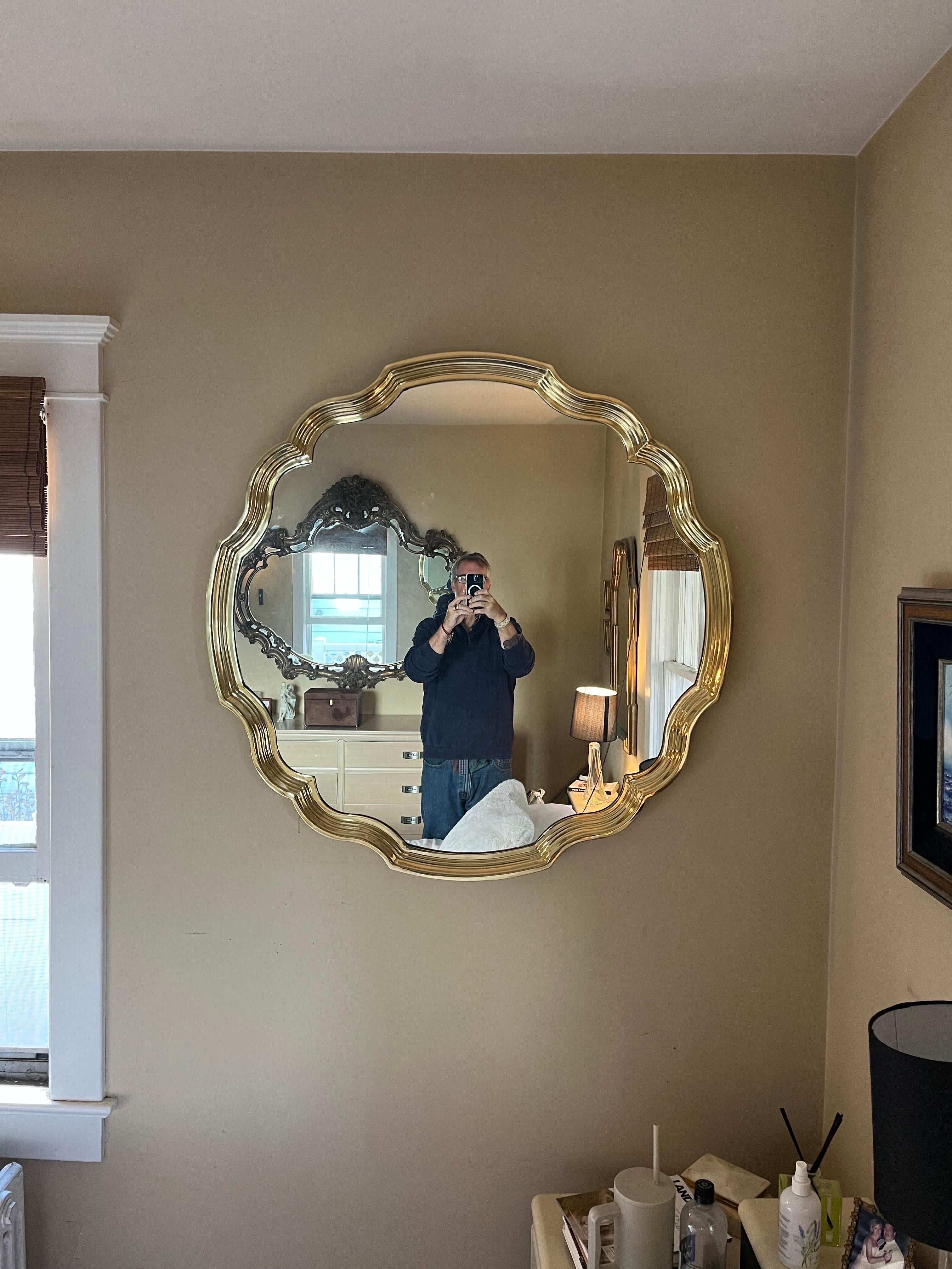 Jaw dropping solid scalloped polished brass mirror by Baker furniture. Unique in it's circular design. Deep channels in the scallop boarder. 
Curbside to NYC/Philly $400