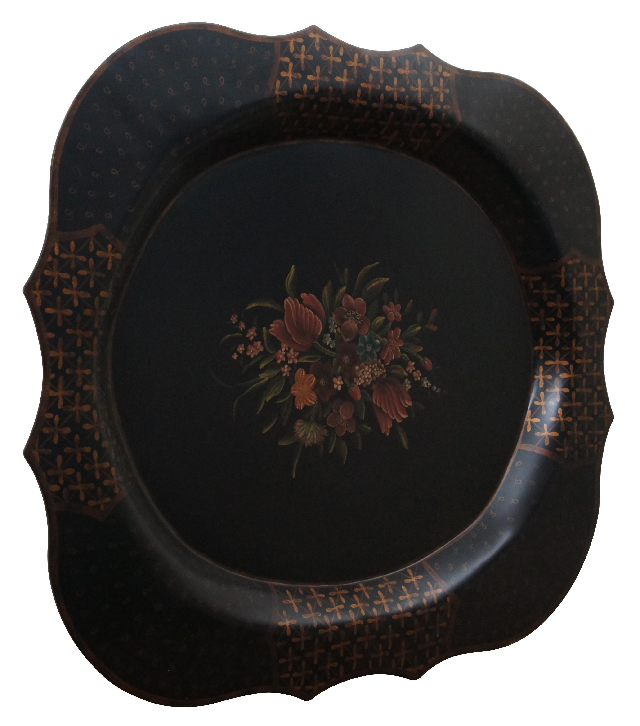A large and impressive over-sized black scalloped toleware tray with gold accents along the edges and a bouquet of flowers at the center. Wood panel and picture wire added to back for hanging on the wall.