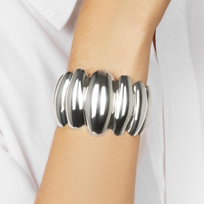 This vintage silver cuff bracelet features a striking puffed, scalloped design.  The bracelet is vintage from approximately 1970 and has been lightly polished to bring out its original lustre.  The bracelet is on the smaller size in terms of fit and