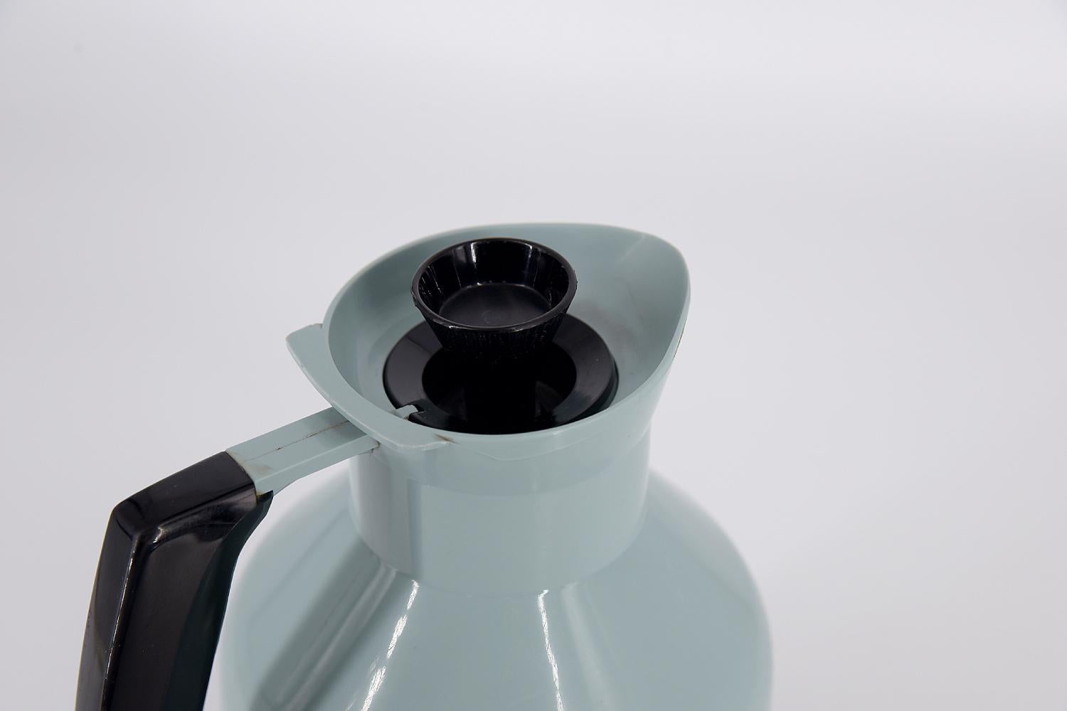 This thermal jug was designed by G. Rosendahl for the Swedish Falkenberg manufacture during the 1960s. Thermos flask made of blue and black plastic. The handle, lid and bottom are black. The cork is designed in which the rubber expands and contracts