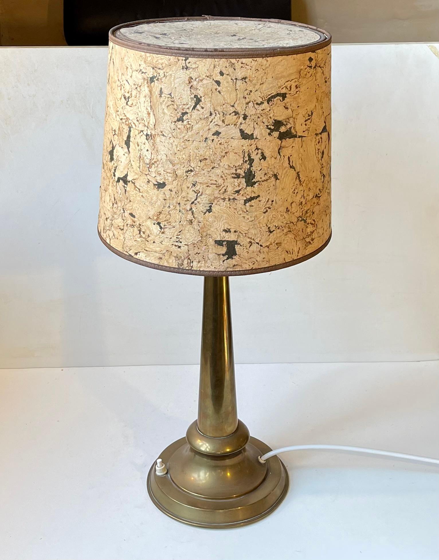 A column shaped brasss table light featuring a handmade cork shade. A very rare vintage shade configuration. Its a large desk or table lamp with a height of 57 cm and featuring an on/of switch to its base. Measurements: Diameter: 27/14 cm