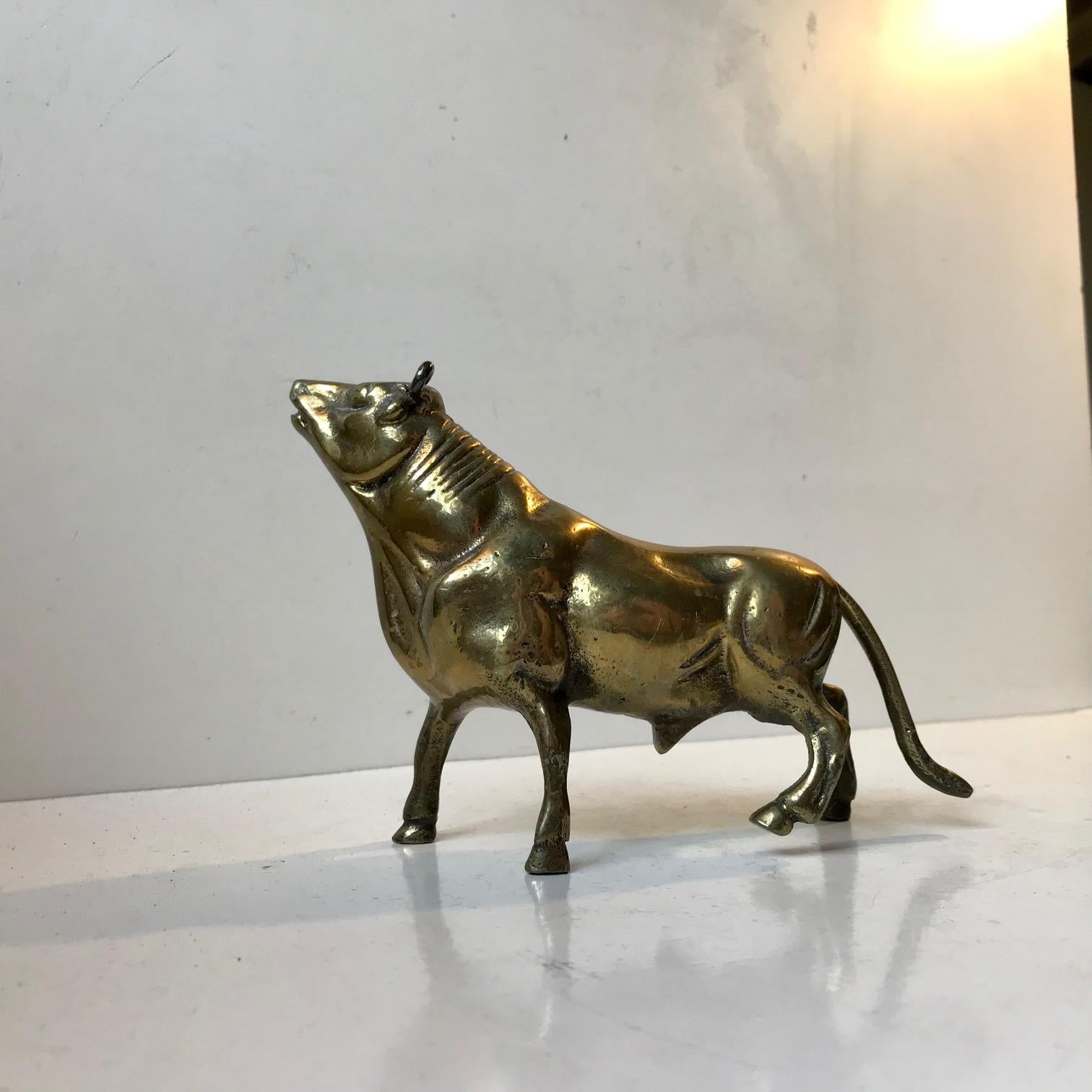 Scandinavian figurine or small sculpture of a young bull. It is made from cast brass and shows great details and rich patina consistent with its age. Measurements: W/L: 19 cm, H: 12.5 cm.