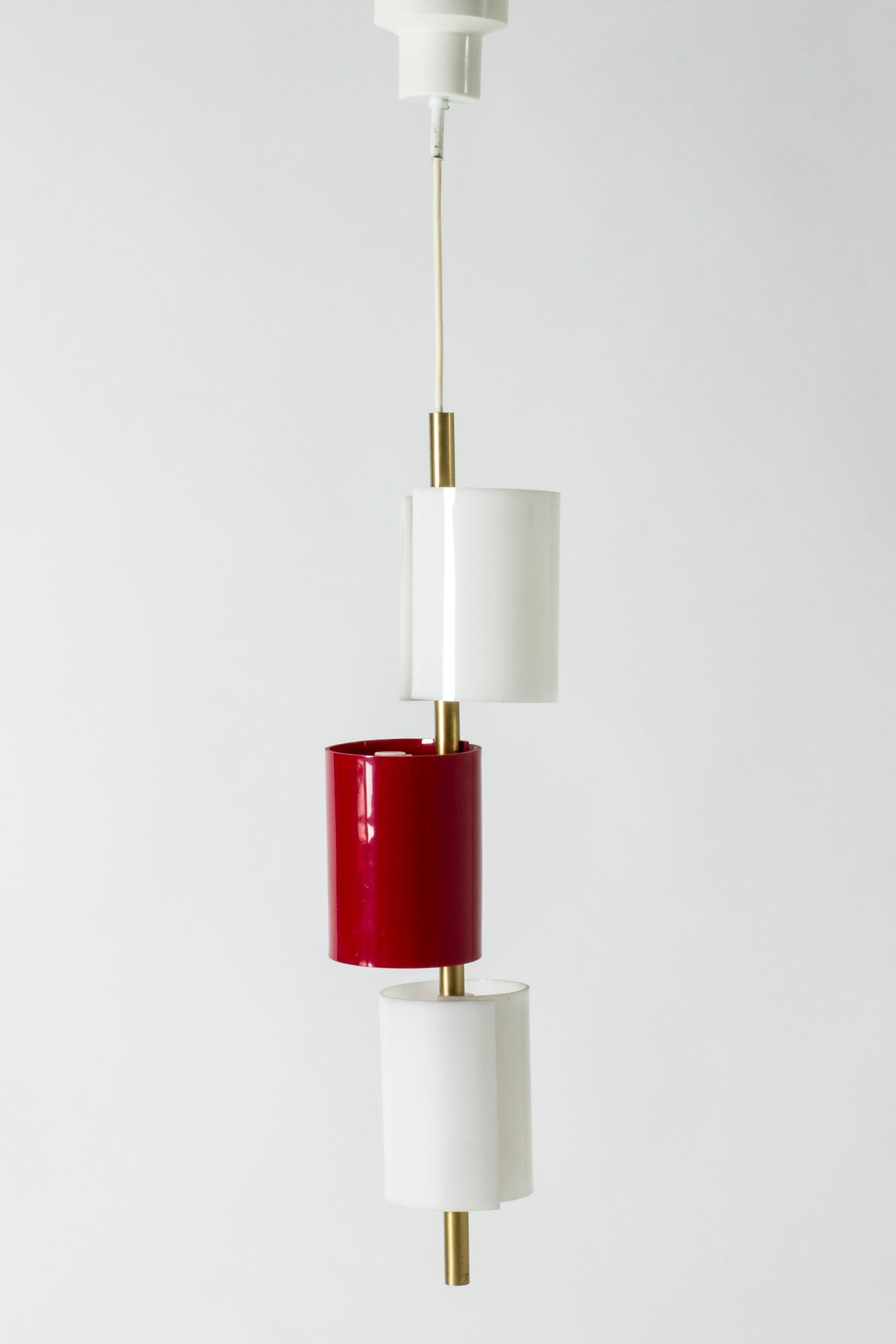 Cool ceiling lamp by Hans Bergström, made from brass with three thick plastic shades, curling into cylinders. White and striking lipstick red.

Hans Bergström was the owner and creative director of the lighting firm Ateljé Lyktan, which he founded