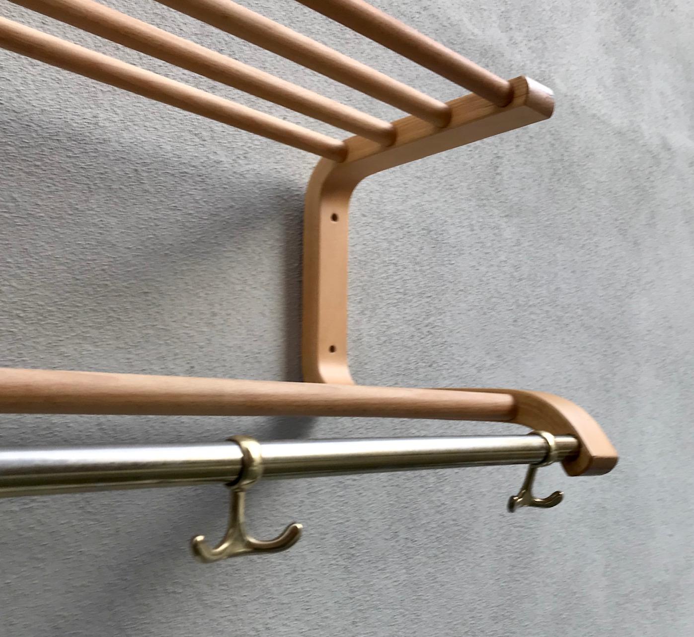 This coat and hat rack was probably manufactured by Artek in Finland during the 1970s. It is in the style of Alvar Aalto design for his own villa in 1936. The mounts/sides are made from hand-bent lacquered birch, the sticks from solid birch and the