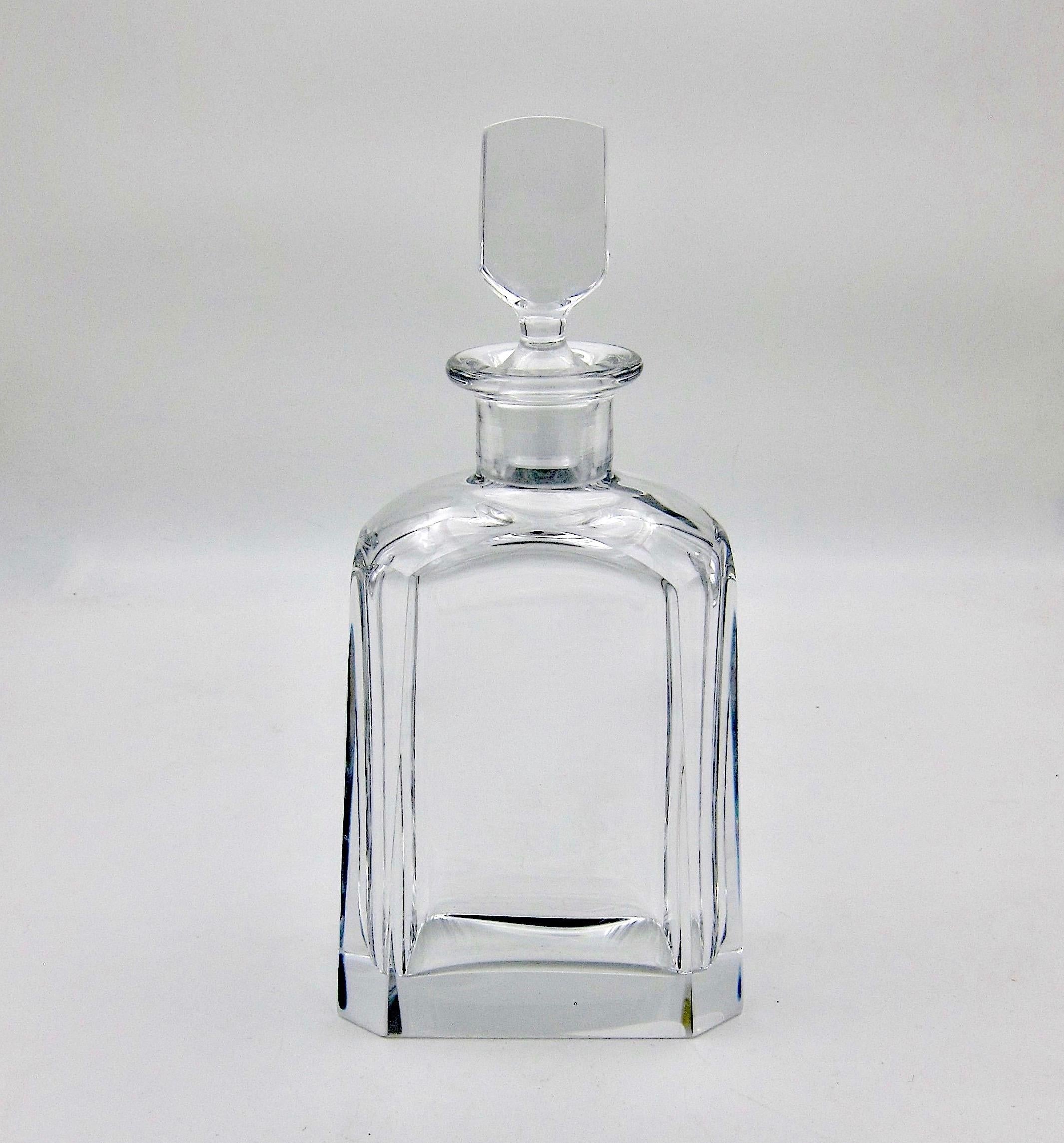 A vintage Scandinavian cut crystal decanter designed by Sven Palmqvist (Palmquist) for Orrefors of Sweden. The elegant and minimal spirit decanter of heavy clear crystal features a substantial base, four canted corners, and its original stopper.