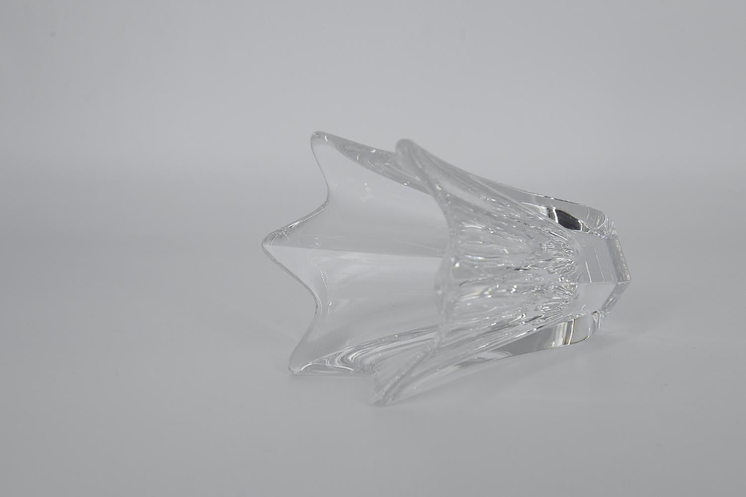 This Tulip crystal vase was designed by Jan Johansson for the Swedish glassworks Orrefors during the 1970s. Transparent vase made of lead art crystal glass. It is shaped like a tulip with six petals.

Jan Johansson was born in 1942. He came to