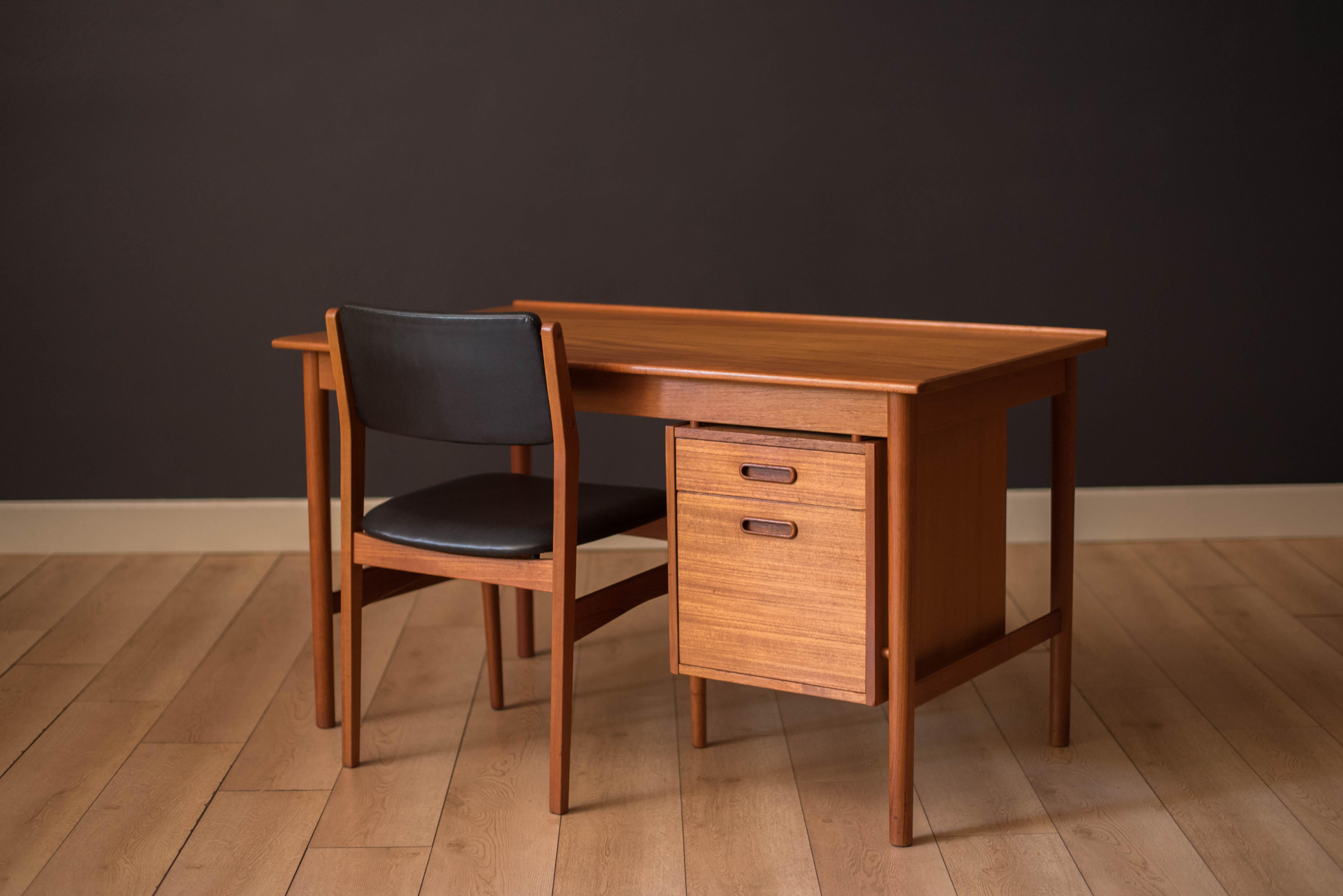 Mid Century Modern office desk in teak manufactured by Dux of Sweden, circa 1960's. This unique piece features a floating drawer bank accented with sculpted pulls. Desktop provides plenty of surface area featuring a raised lip edge and external