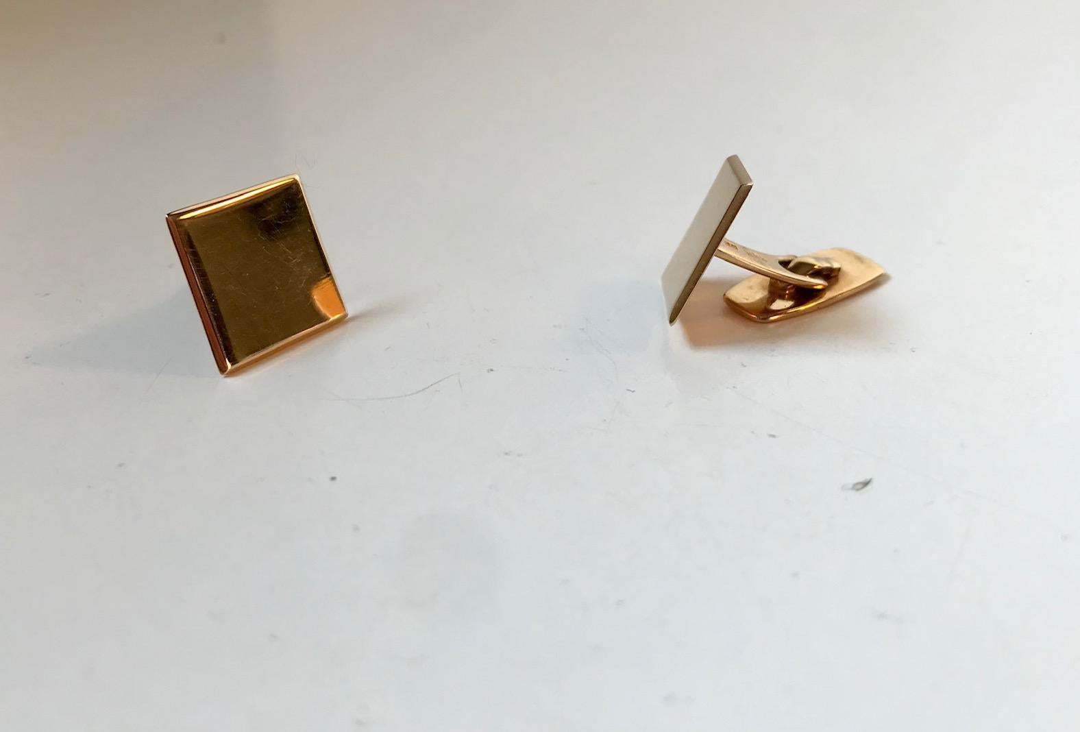 Square rounded of solid gold cufflinks made from 14-carat yellow gold. Nordic minimalism and purity comes alive in this subtle pair of vintage 1970s cufflinks. Manufactured and designed by Randers Sølv during the 1970s. Both imprinted with hall- and