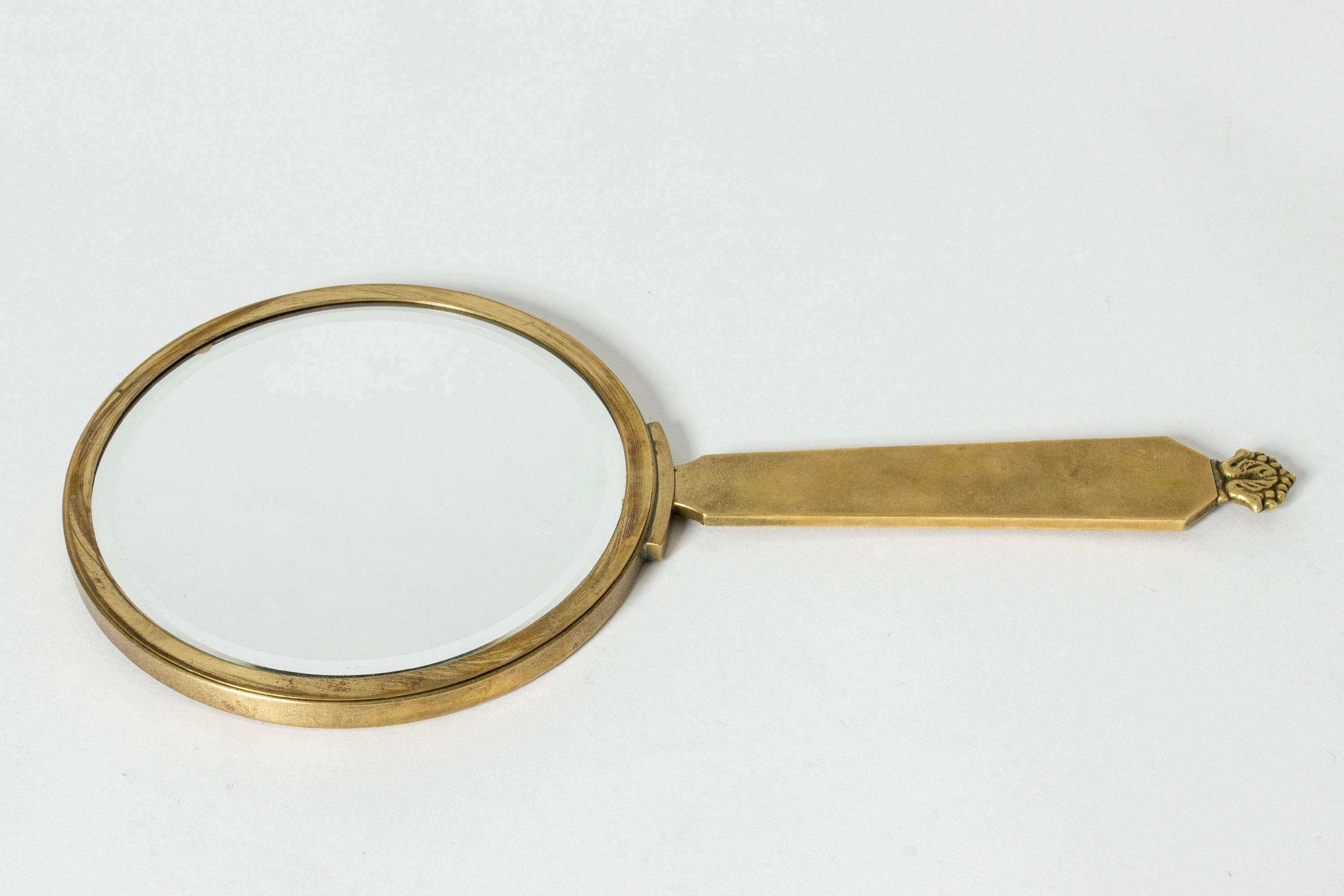 Lovely hand mirror by Oscar Antonsson, made from brass with decor of a woman washing her hair on the back.