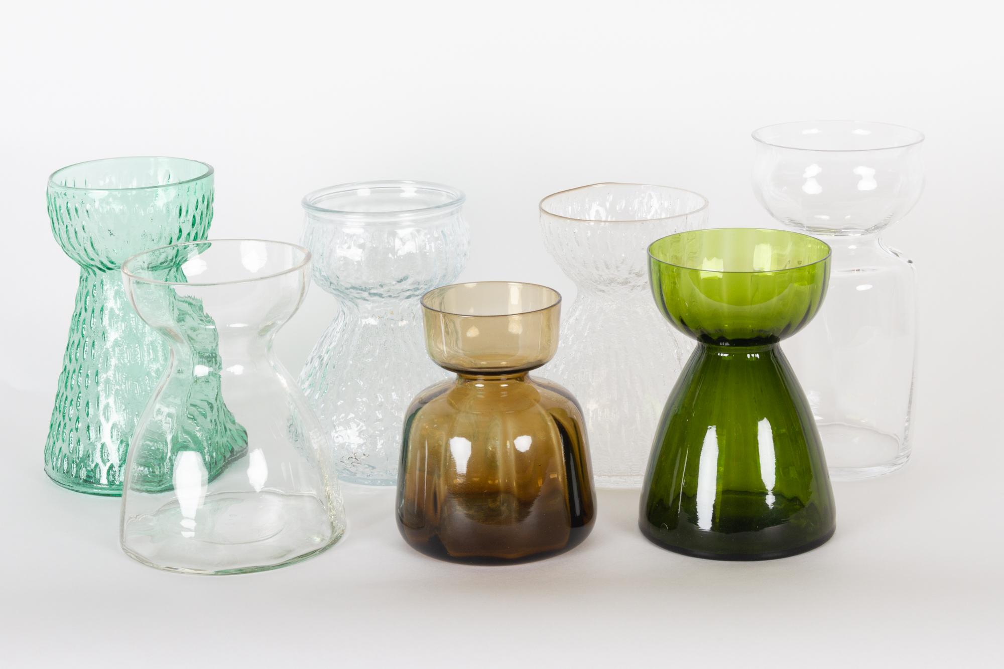 Vintage Scandinavian Hyacinth glass vases, 1960s
Set of seven Mid-Century Modern vases. This type of vases was very common in Scandinavia where they were used for hyacinths. The flower bulb is supported on the top of the vase, and the roots extends