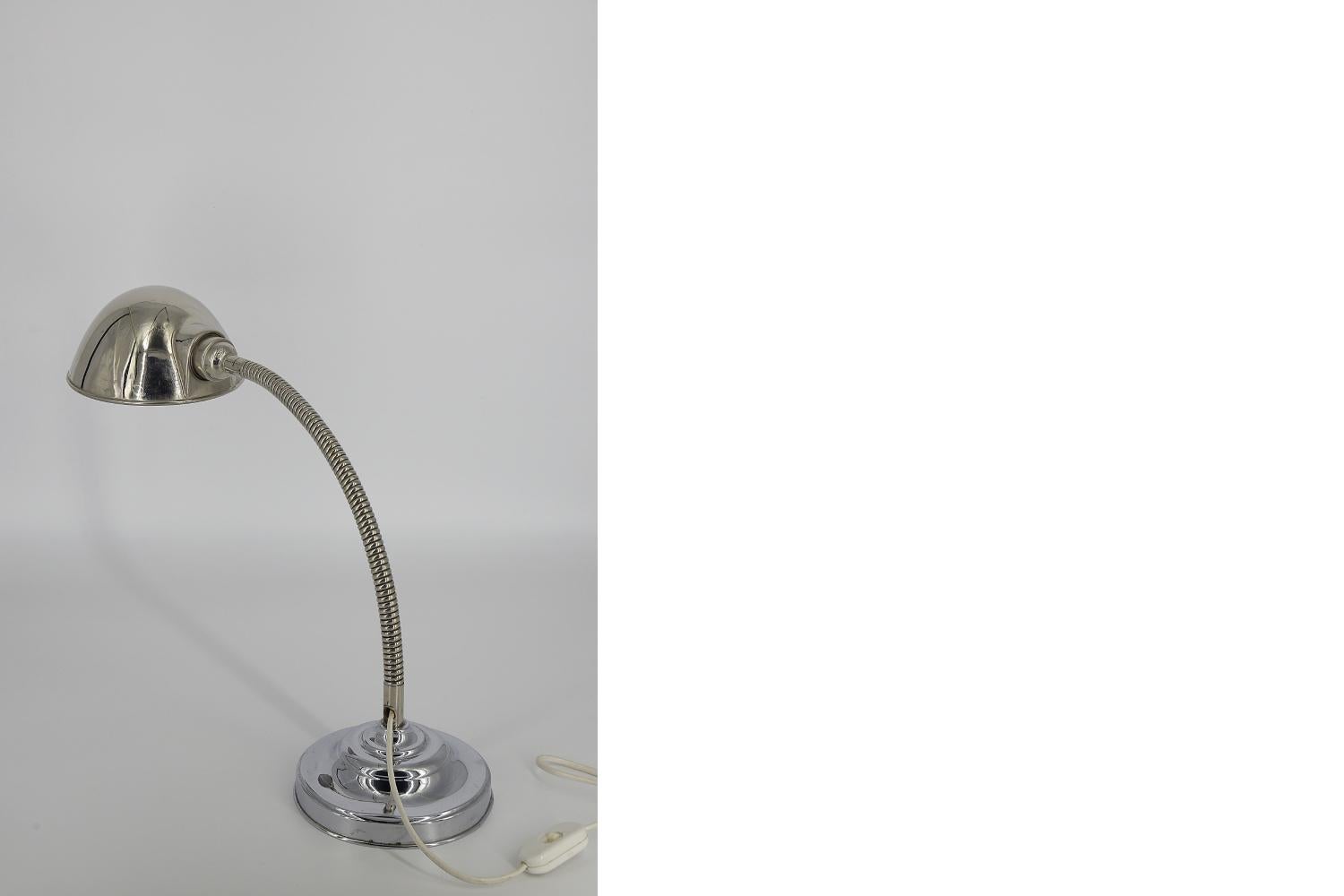 This classic desk lamp was produced in Scandinavia during the 1960s. It has elements of the German manufacturer of electrotechnical elements Vossloh Werke Zenith. The lamp has a solid, chrome base with a flexible arm and a parabolic diffuser. The