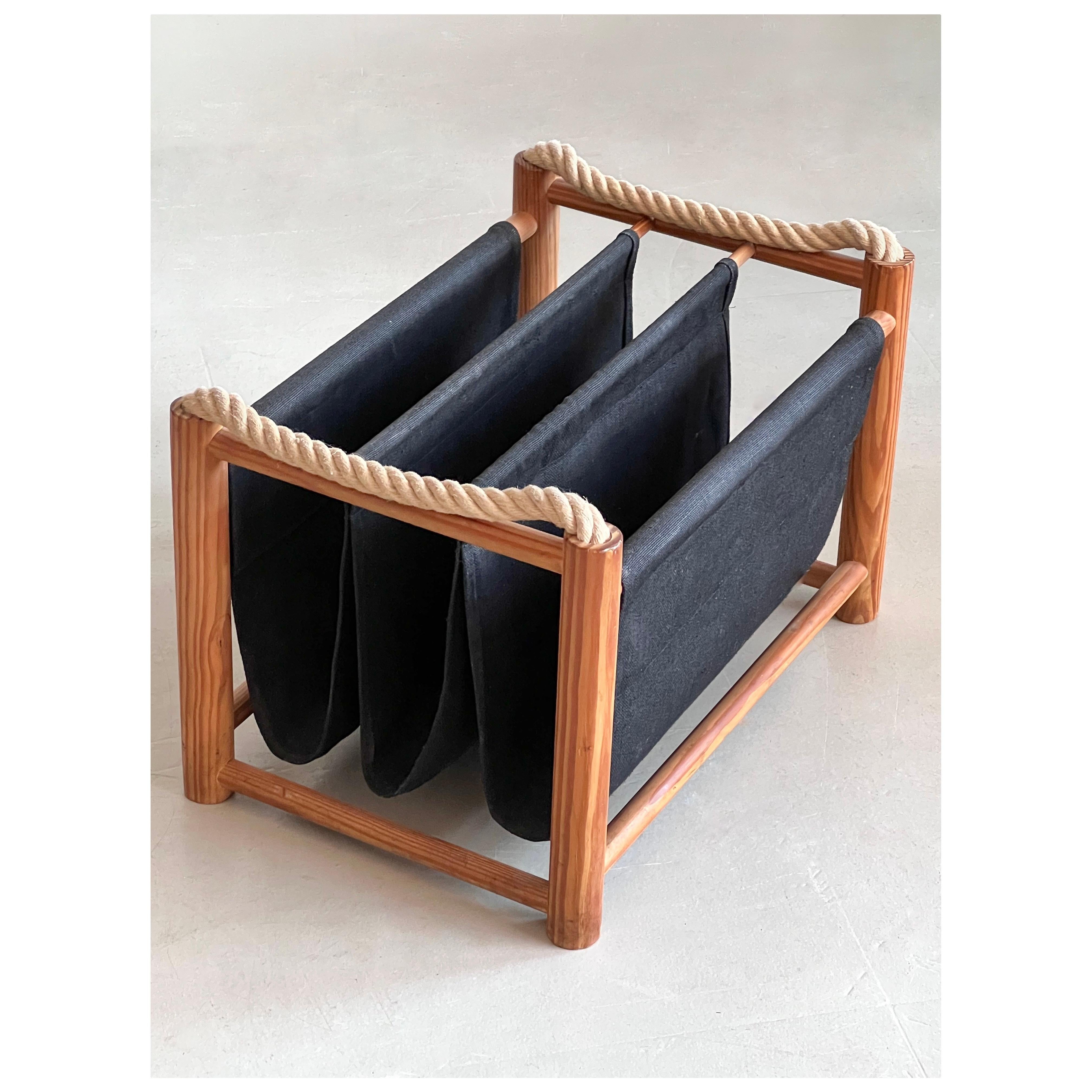 Danish magazine rack in pine, black fabric for the compartiments and 2 handles in cord. 
Magazine addicts of all time! Do you also have a pile that you still want or need to go through? 
Collect them here in this Danish magazine rack, easy to move