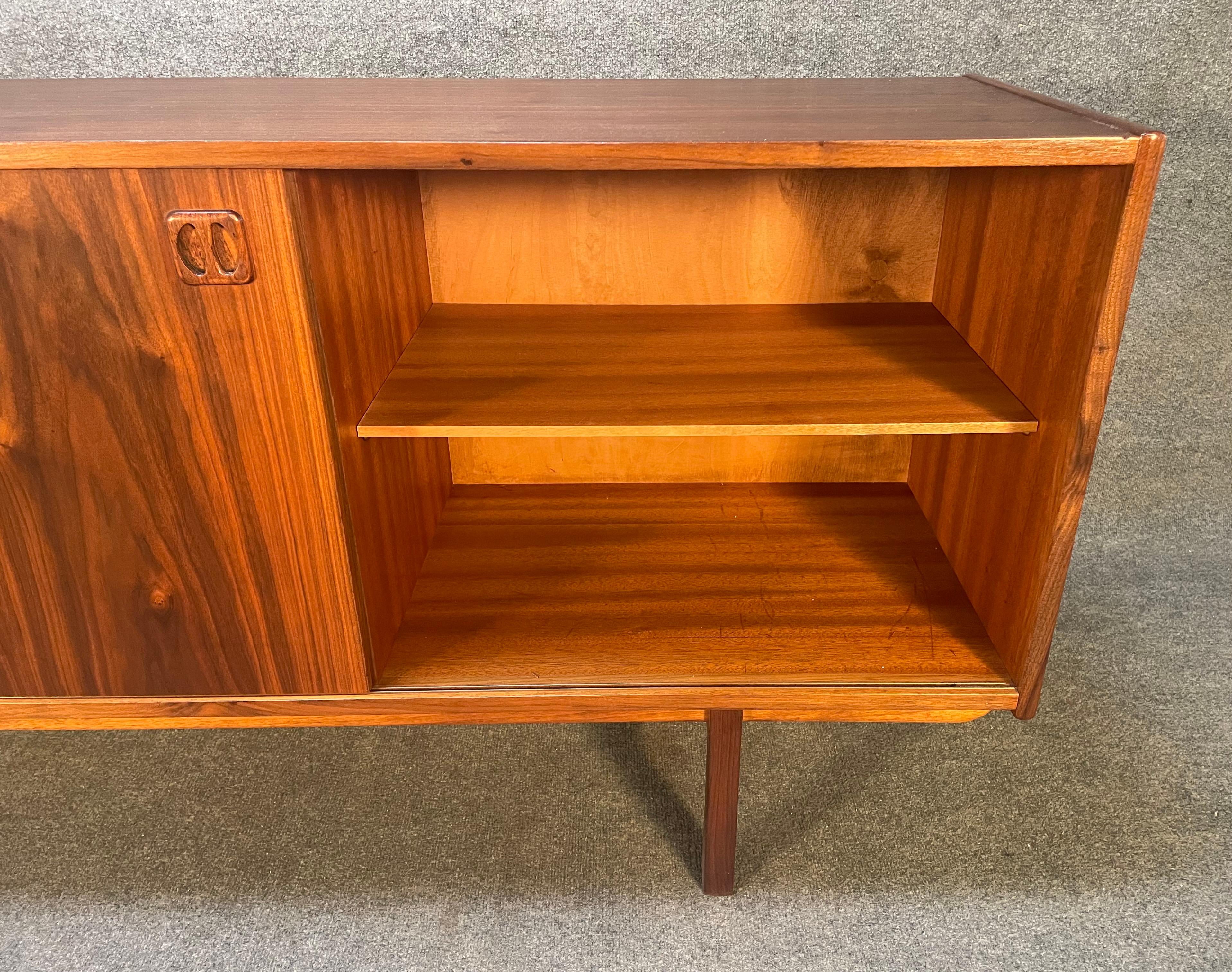 Here is a beautiful Scandinavian modern sideboard in walnut model 