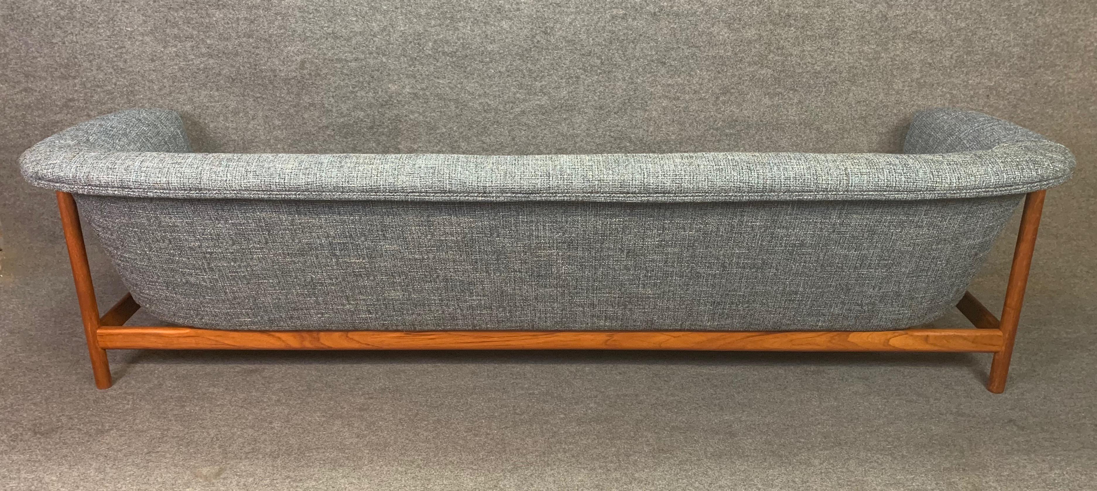Here is a rare and beautiful Scandinavian Modern teak sofa manufactured by Westnoga in Norway in the 1960s.
This comfortable couch features a refinished solid teak frame and received a brand new foam and period correct textured upholstery in