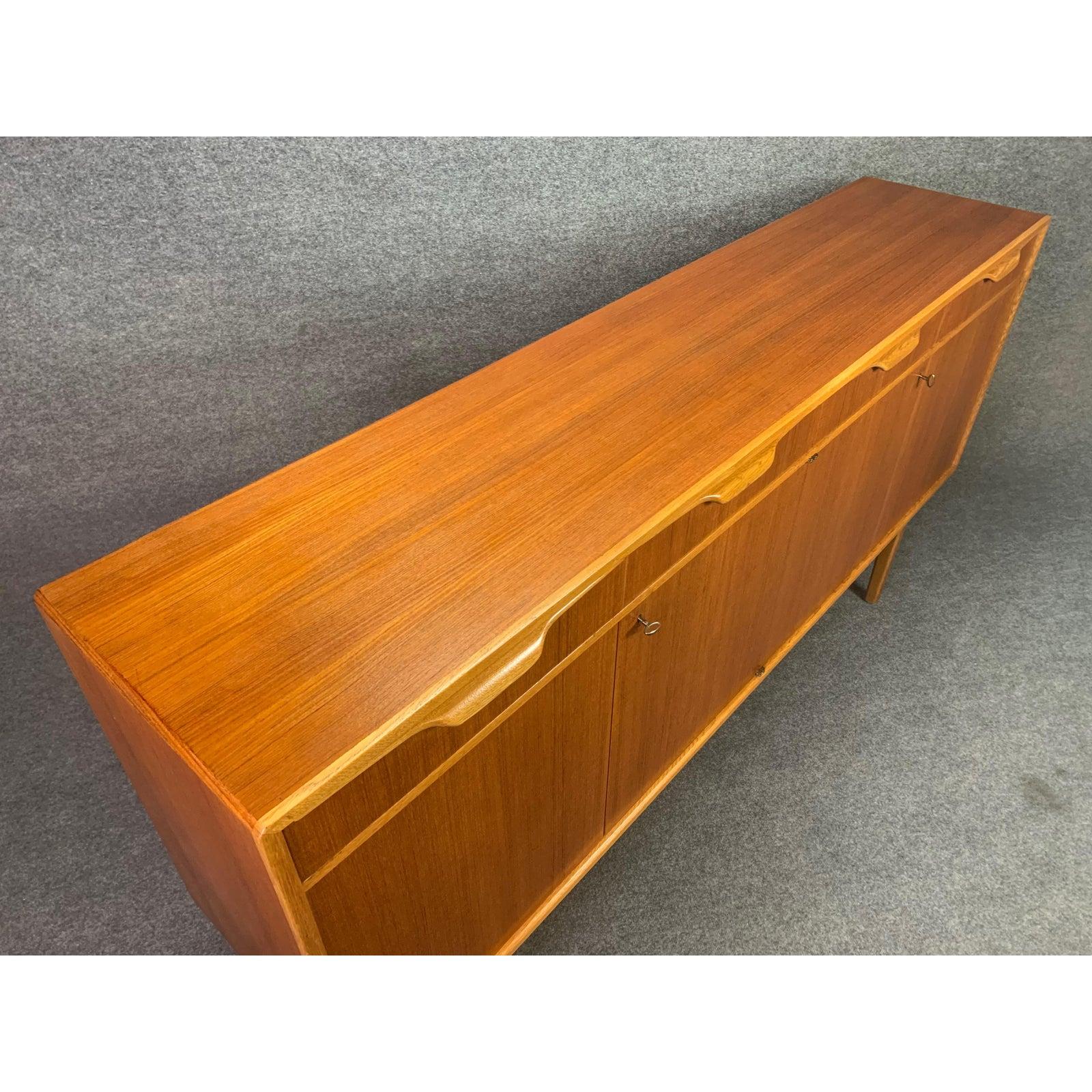 $300 WHITE GLOVE DELIVERY SHIPPING TO KANSAS CITY, MO
Here is a beautiful Scandinavian modern sideboard in teak and oak designed by Bertil Fridhagen and manufactured by Bodafors in Sweden, 1960.
This exquisite piece, recently imported from Stockholm