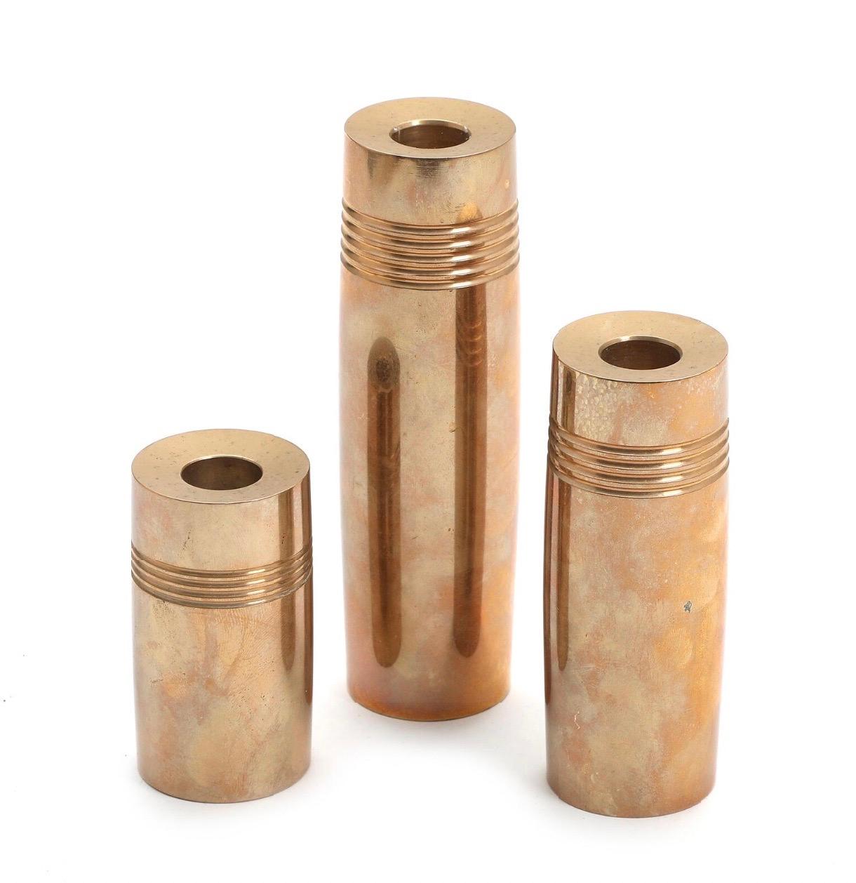 Set of 3 bronze cylindrical candleticks 

Measuring approx 3.5