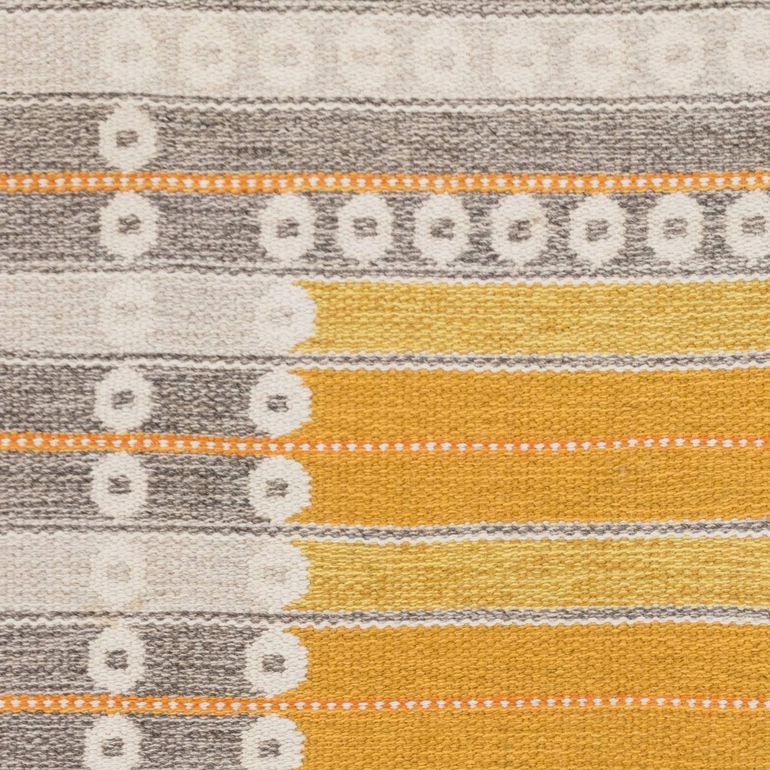 Sunny and thick vintage double sided Swedish rug by Ingrid Dessau, designed for Kasthall. Signed ID. In this particular Swedish rug there are abstracts elements with yellow, orange and grey. The result is a soft warm and inviting effect, and the