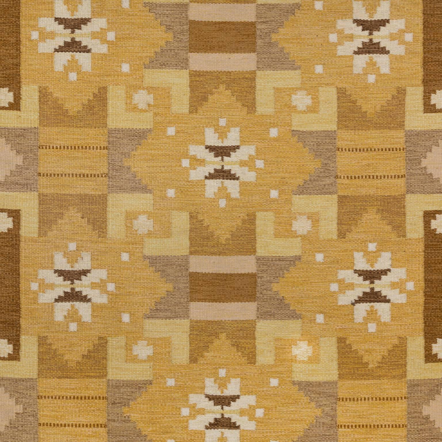 An appealing, warm and welcoming rug from the Scandinavia Modern era. Characterized by an exciting and complex design of geometric figures. This lovely vintage kelim features a pallet of yellow and tan. Sophisticated composition with a posh energy.