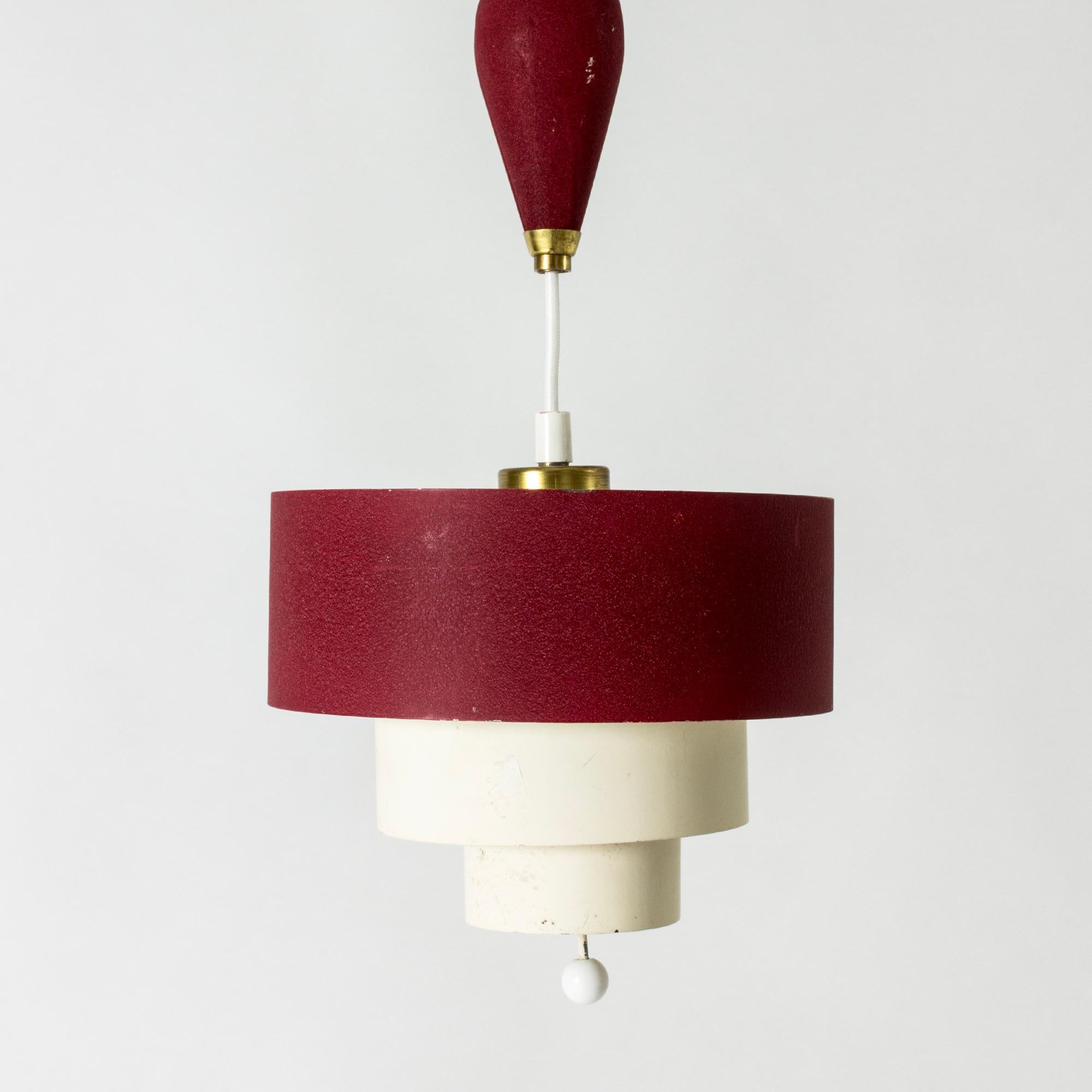 Cool ceiling lamp by Bertil Brisborg, with original lacquer in red and white. Cute ball detail at the bottom.  Height is easily adjusted with the weight attached to the cord.

Bertil Brisborg was chief architect at the Lighting department at