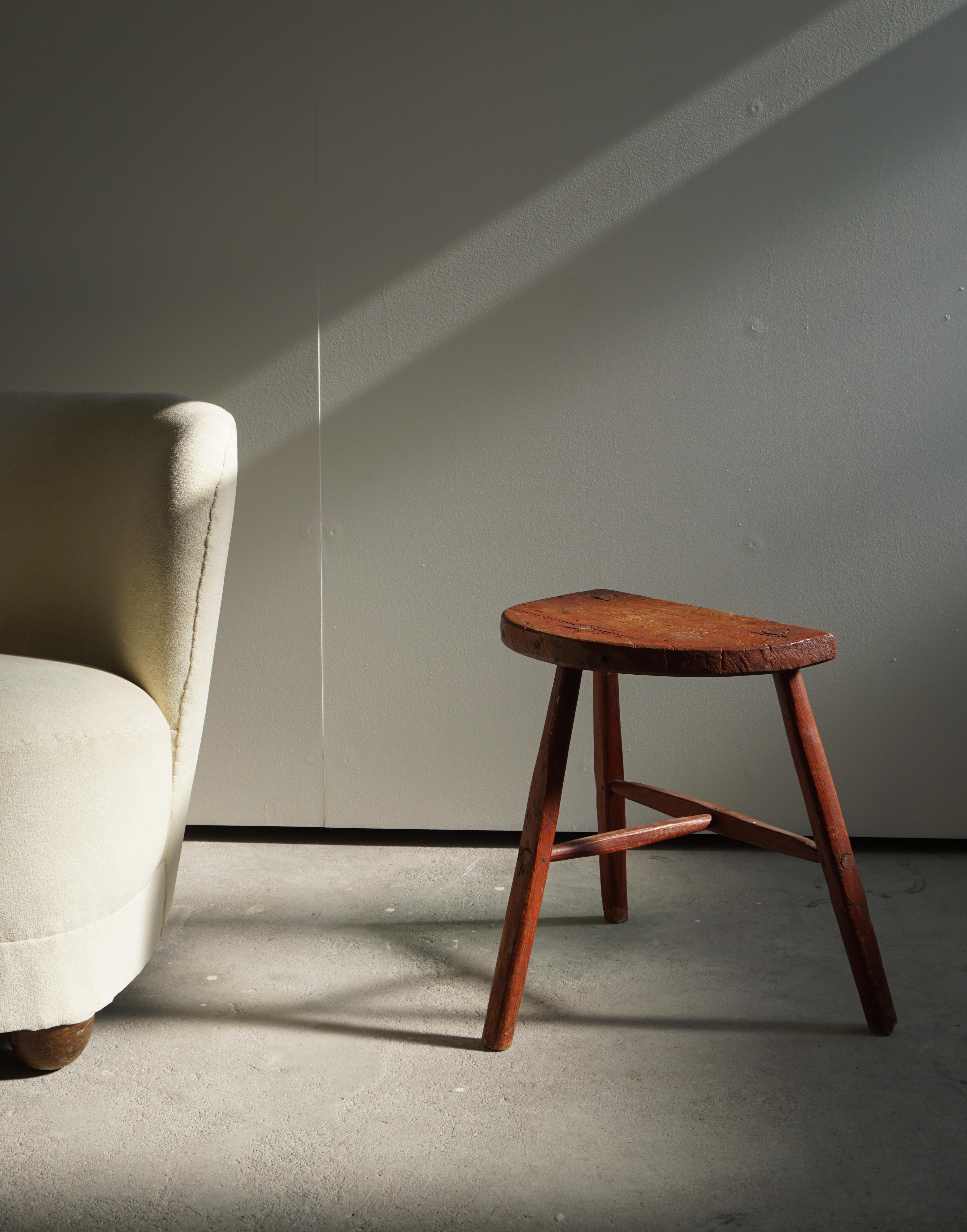 Vintage solid red painted wood stool, Scandinavian Modern design.