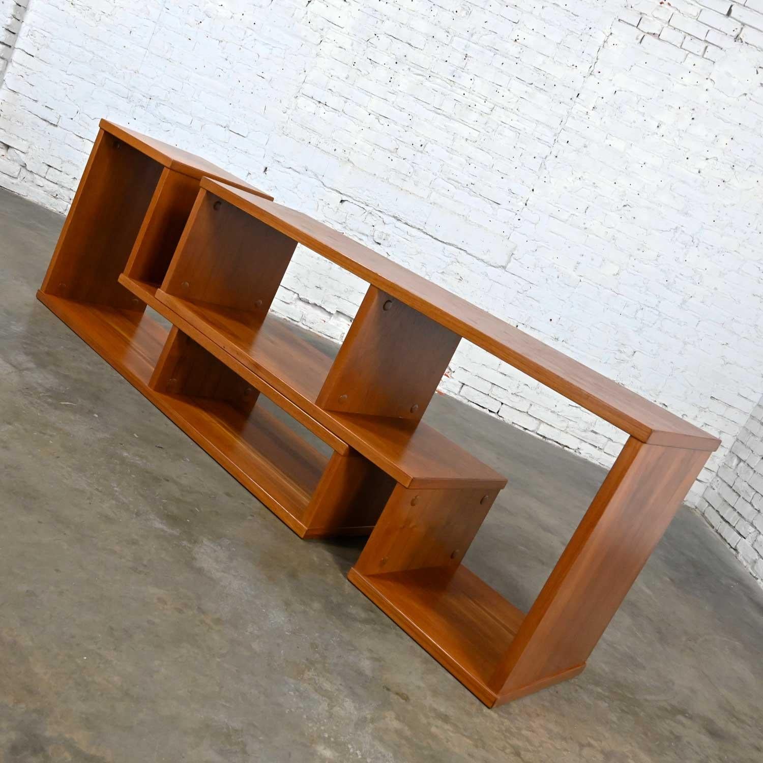 Wonderful vintage Scandinavian Modern teak veneer 2-piece adjustable low bookcase or entertainment center. Beautiful condition, keeping in mind that this is vintage and not new so will have signs of use and wear. Please see photos and zoom in for