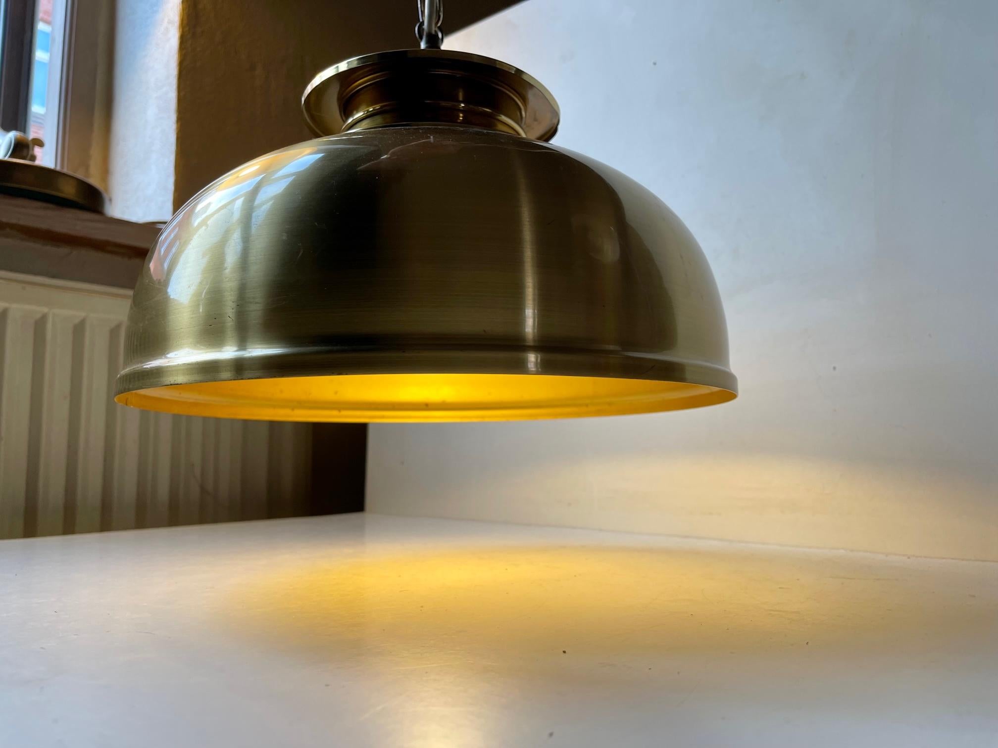 Beatifully made chain-suspended Scandinavian Ceiling Lamp by The style is Nautical/Maritime and it will add a cosy twist to any modern interior. The light is in a very nice vintage condition with a litlle ware and patination to the solid brass