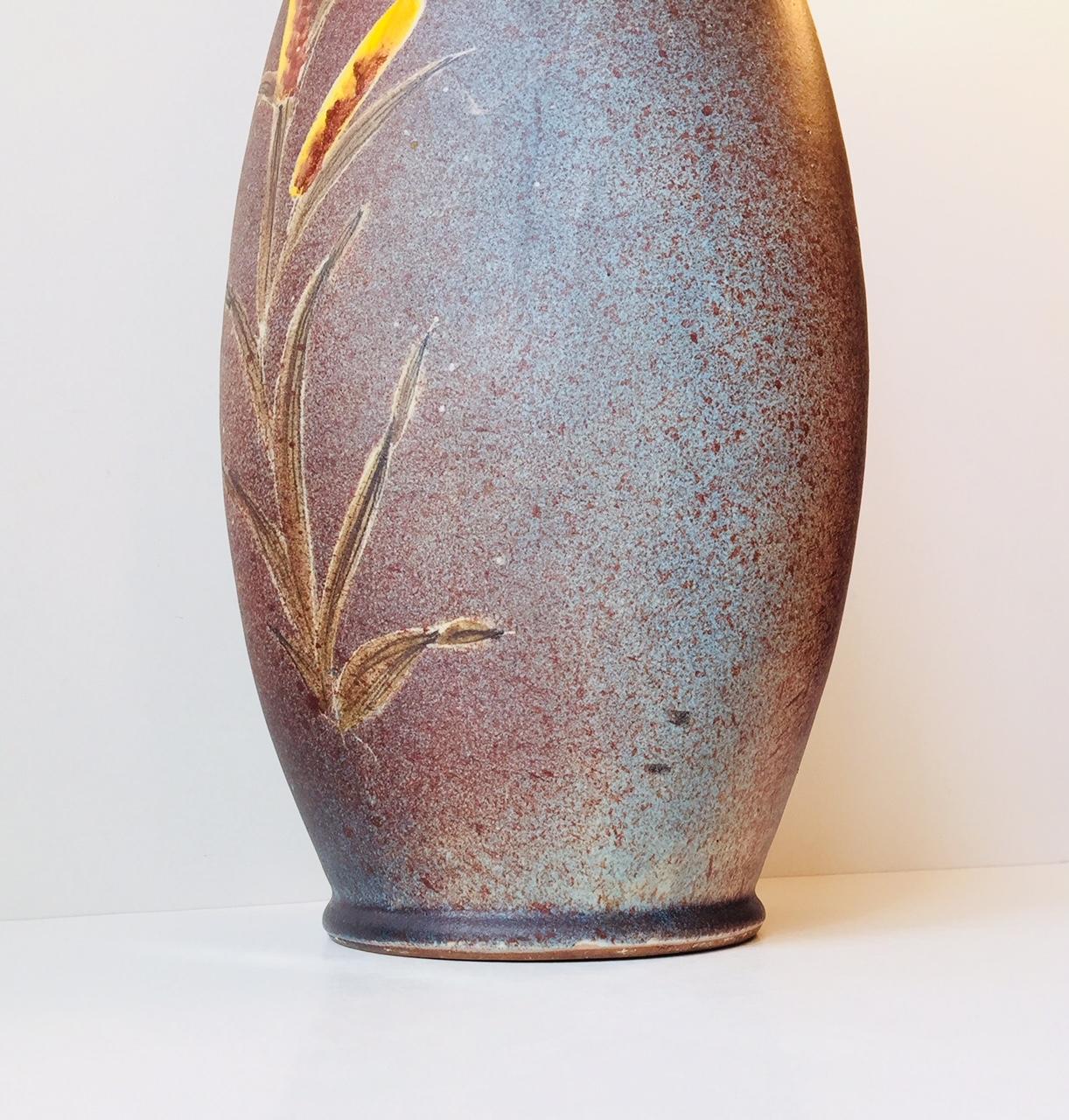 Delicately glazed floor vase in dusty blue, pink and purple glazed and hand-applied glazes depicting ducks to one side and Bulrush' to the other. It is signed Tilgmans, Sweden. The glaze decoration is by C (unidentified). Initial to the front. Fine
