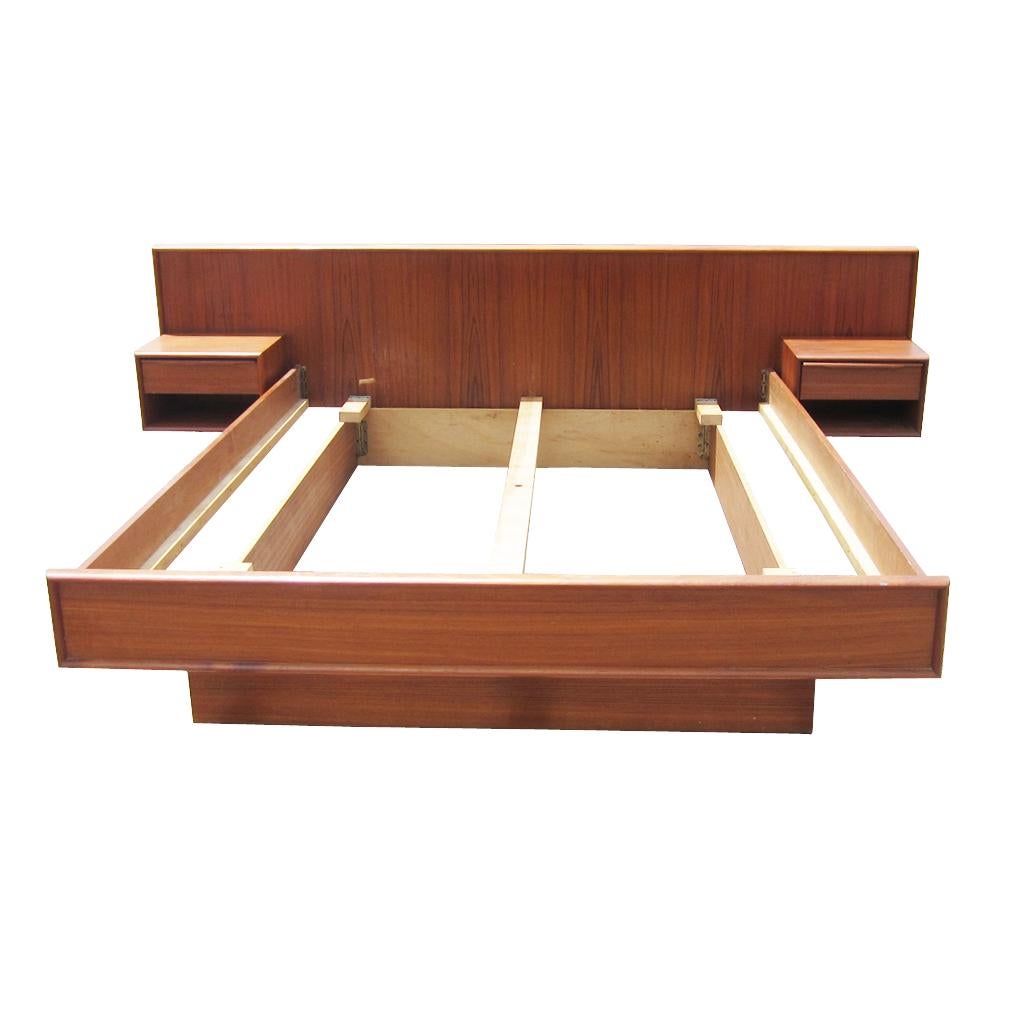 A vintage Scandinavian teak bed set for a queen sized bed. The headboard for this bed has two built in floating nightstands with a drawer for storage. A vintage Scandinavian teak bed set for a queen sized bed. The headboard for this bed has two