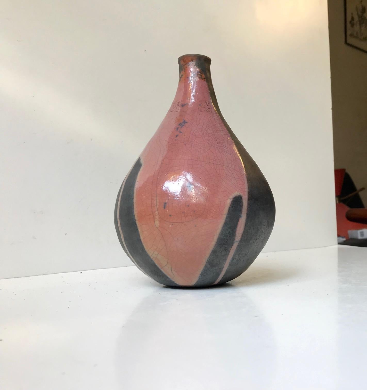 A hand thrown and raku fired ceramic vase by an anonymous Scandinavian designer/maker. This piece is signed but not identified.