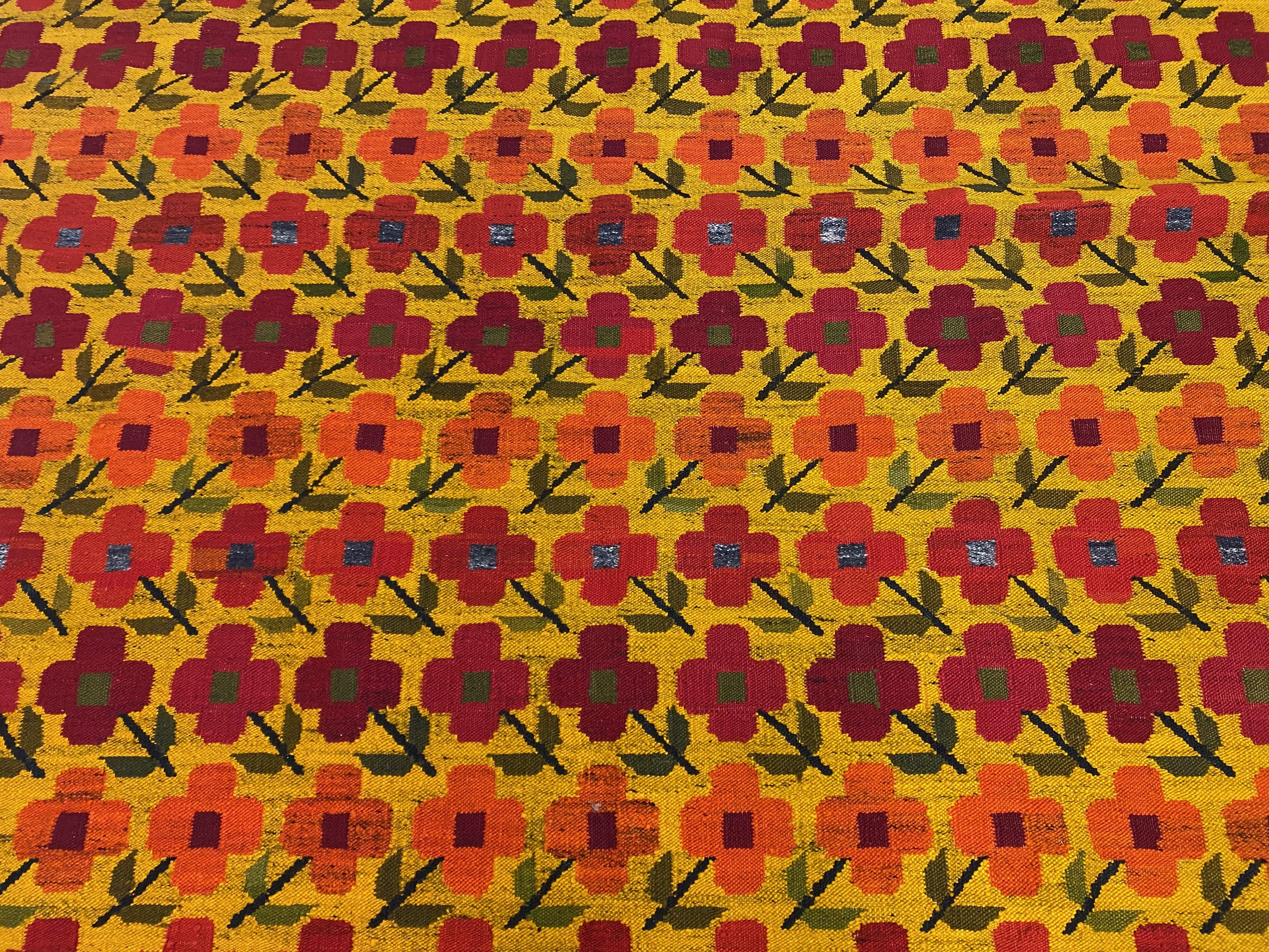 Kilim style rug

Woven wool

Scandinavian

Reversible

Red and orange flowers on yellowish base
      