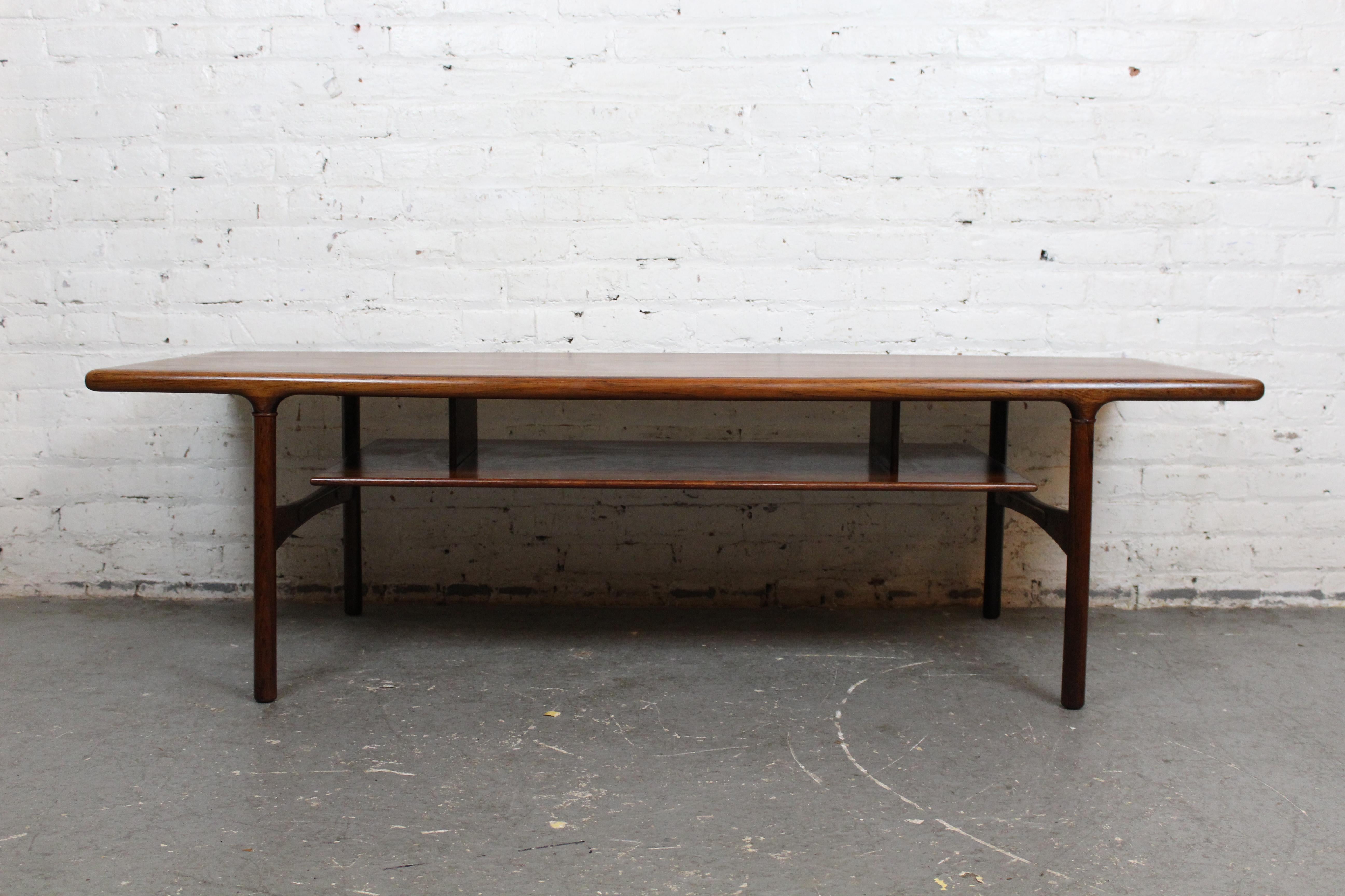 Apportez à la maison des meubles vintage du milieu du siècle qui sont à la fois uniques et utiles avec cette table à cocktail scandinave peu commune ! Fabriqué en bois de rose au grain exquis et doté d'un design flottant pratique à deux niveaux, il