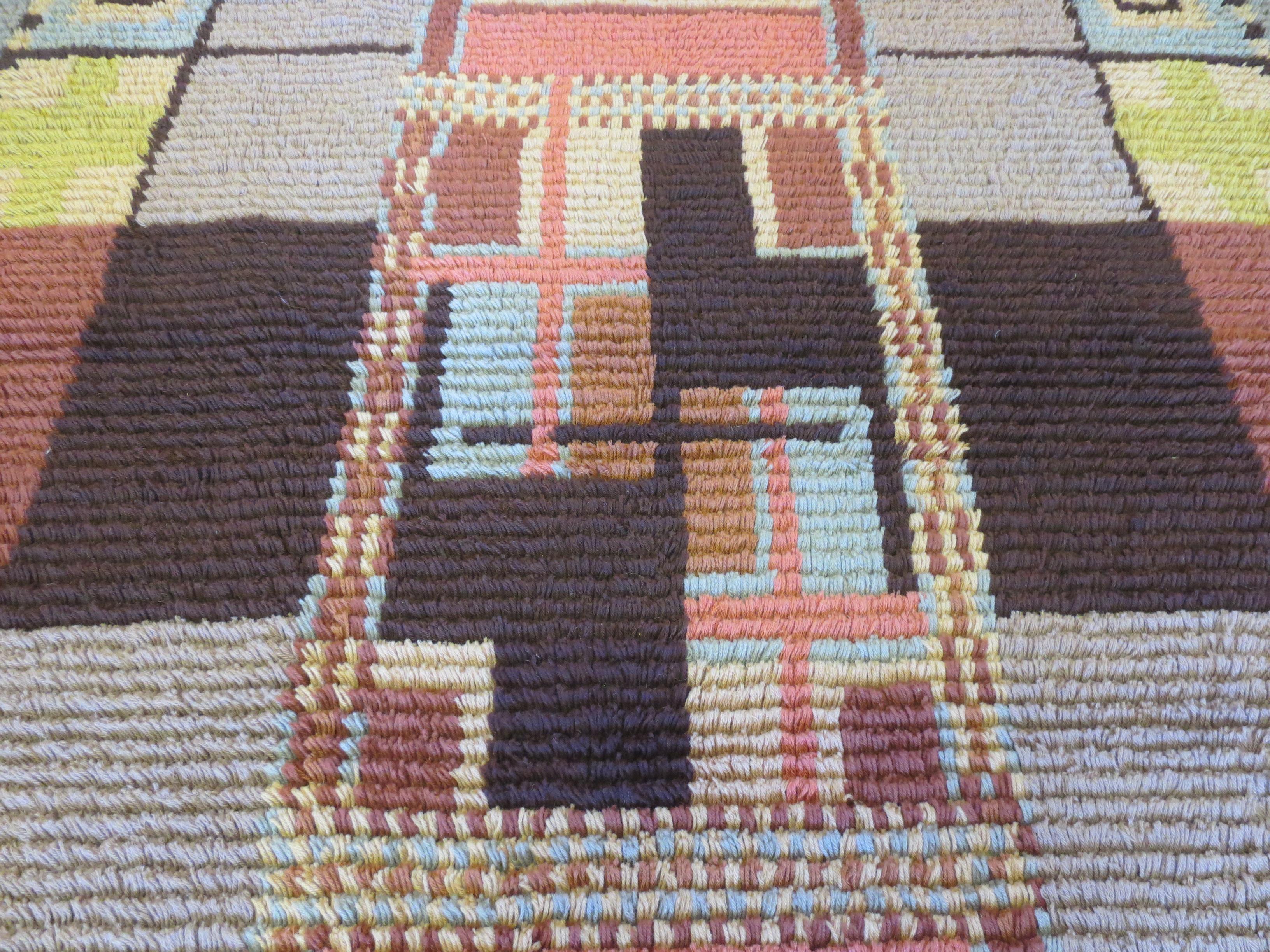 This is a vintage Scandinavian shag rug from the 1930s. It is truly a unique piece signed by the designer and dated 1931. It features skillfully arranged color blocks, with smaller compartments, and rectilinear figures. At its center, it invites the