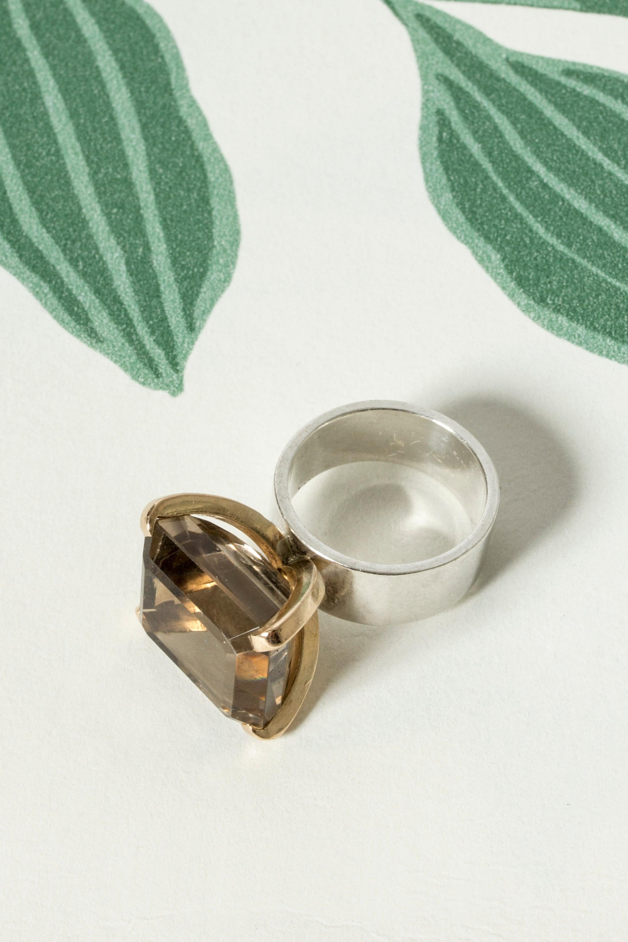 Amazing silver ring by Cecilia Johansson, with a large square smoke quartz stone, elevated in a gold frame. Cool and striking design that combines materials in a beautiful, luxurious way.